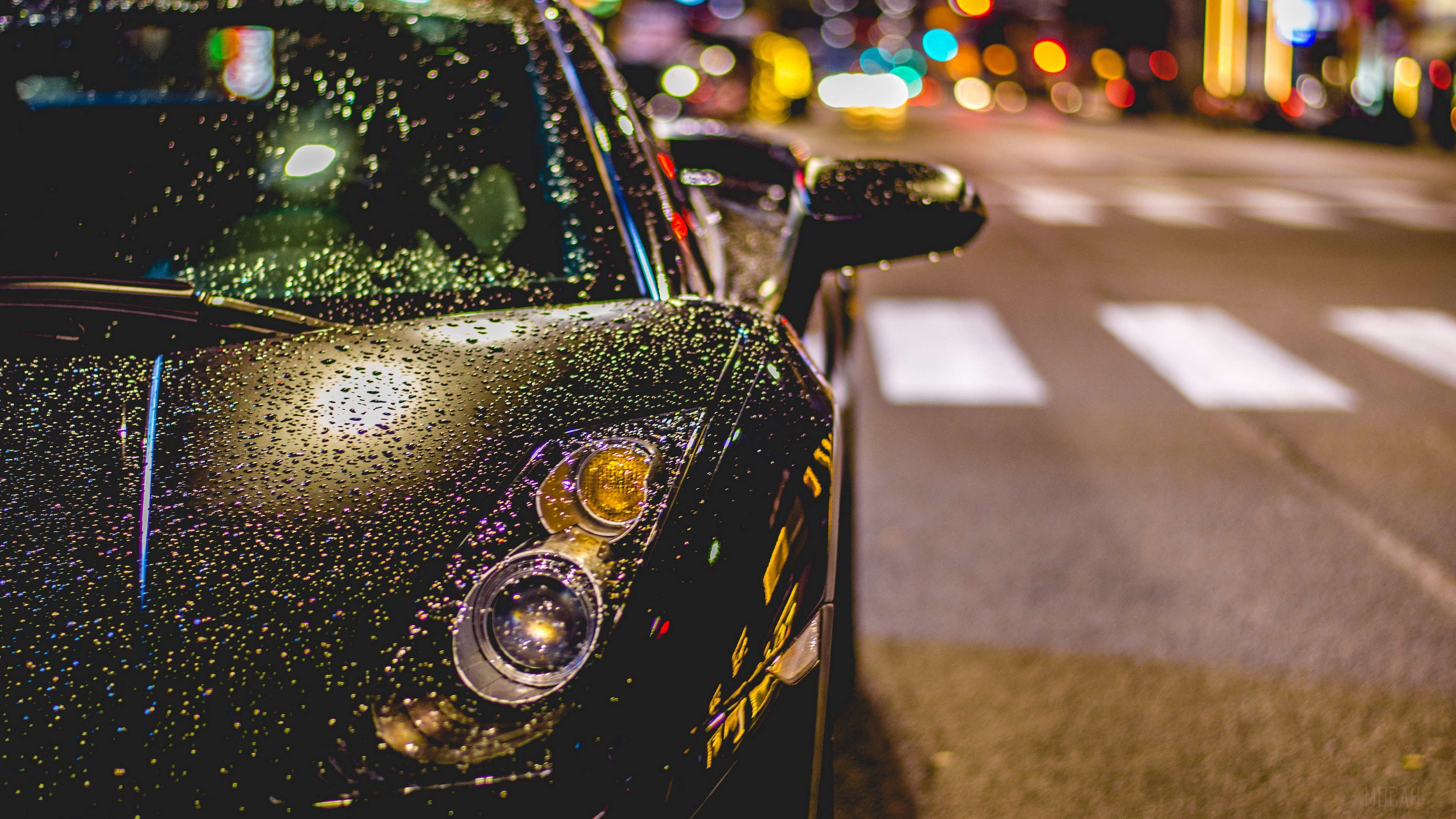 Black car with raindrops on the hood at night HD Wallpaper