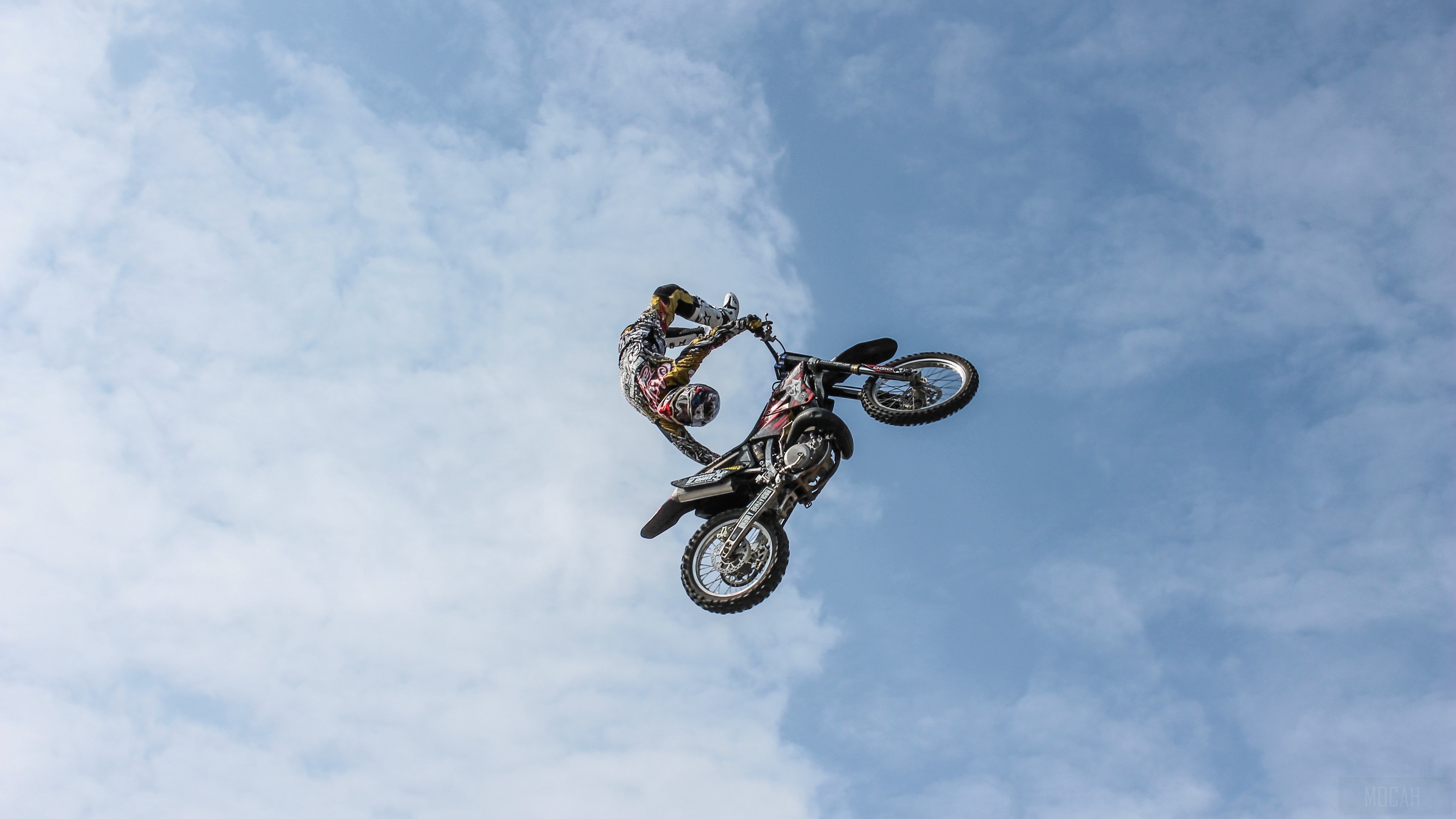 Motocross rider performing a trick in the sky HD Wallpaper