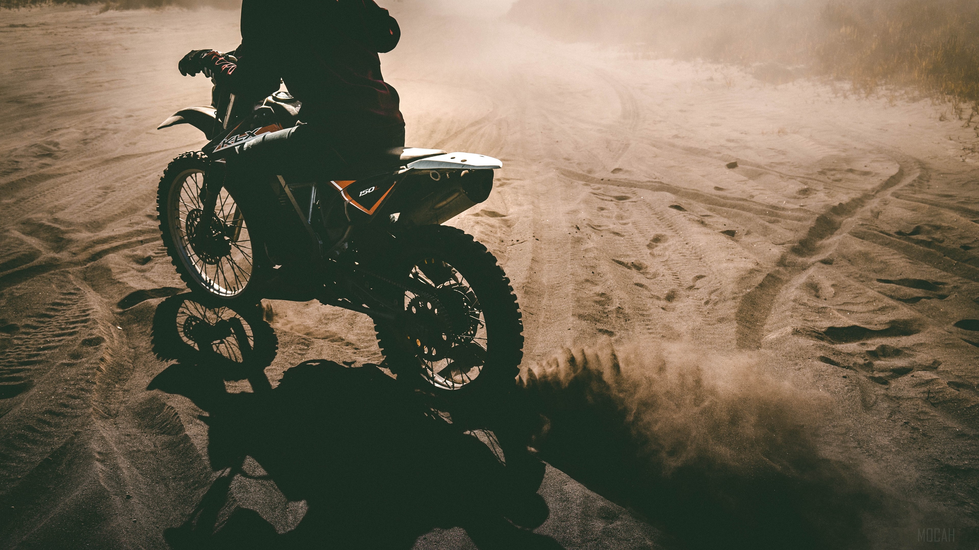 Motorcyclist riding a dirt bike on sand HD Wallpaper