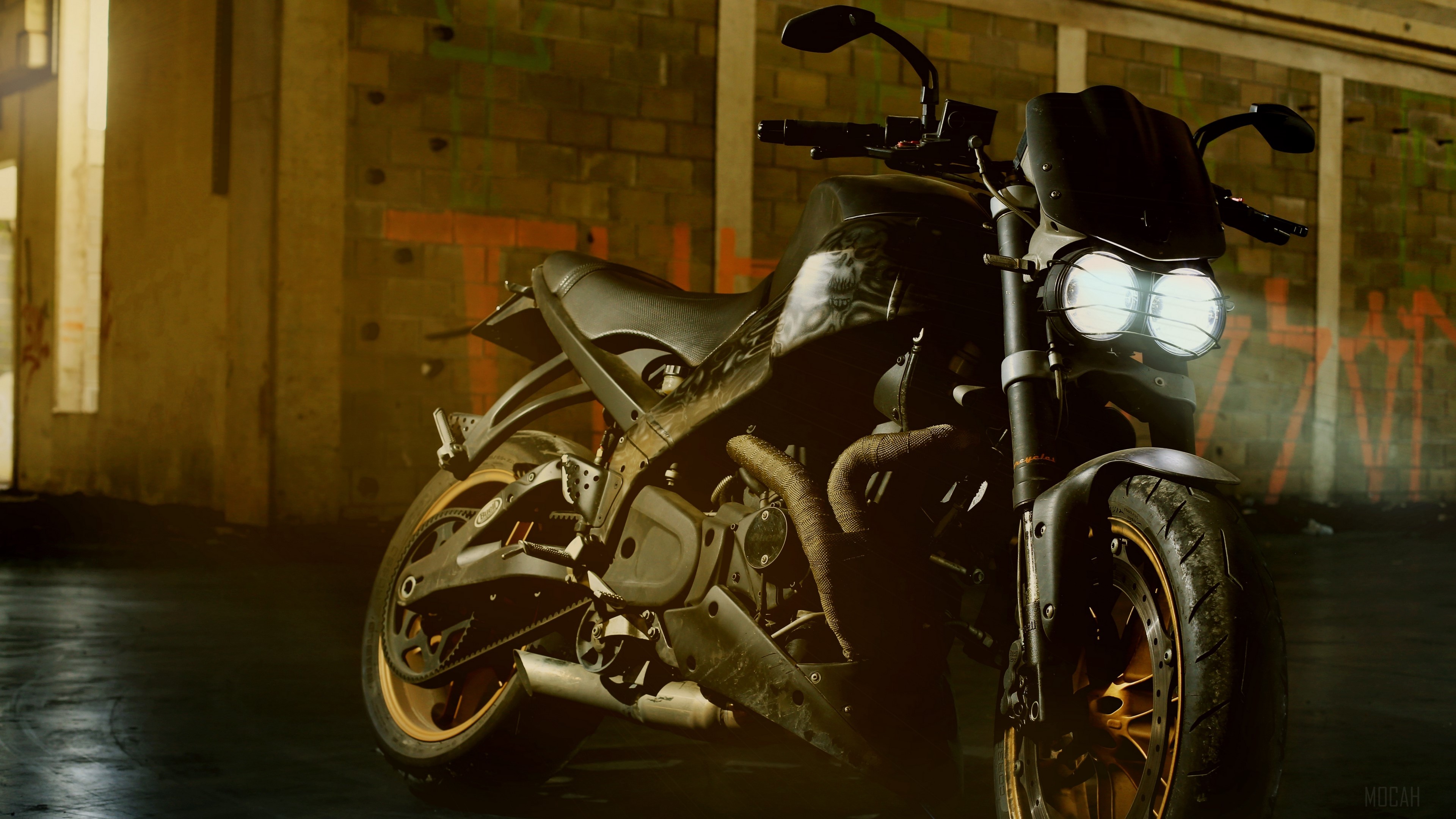 Motorcycle with headlights on in a graffiti-covered building HD Wallpaper