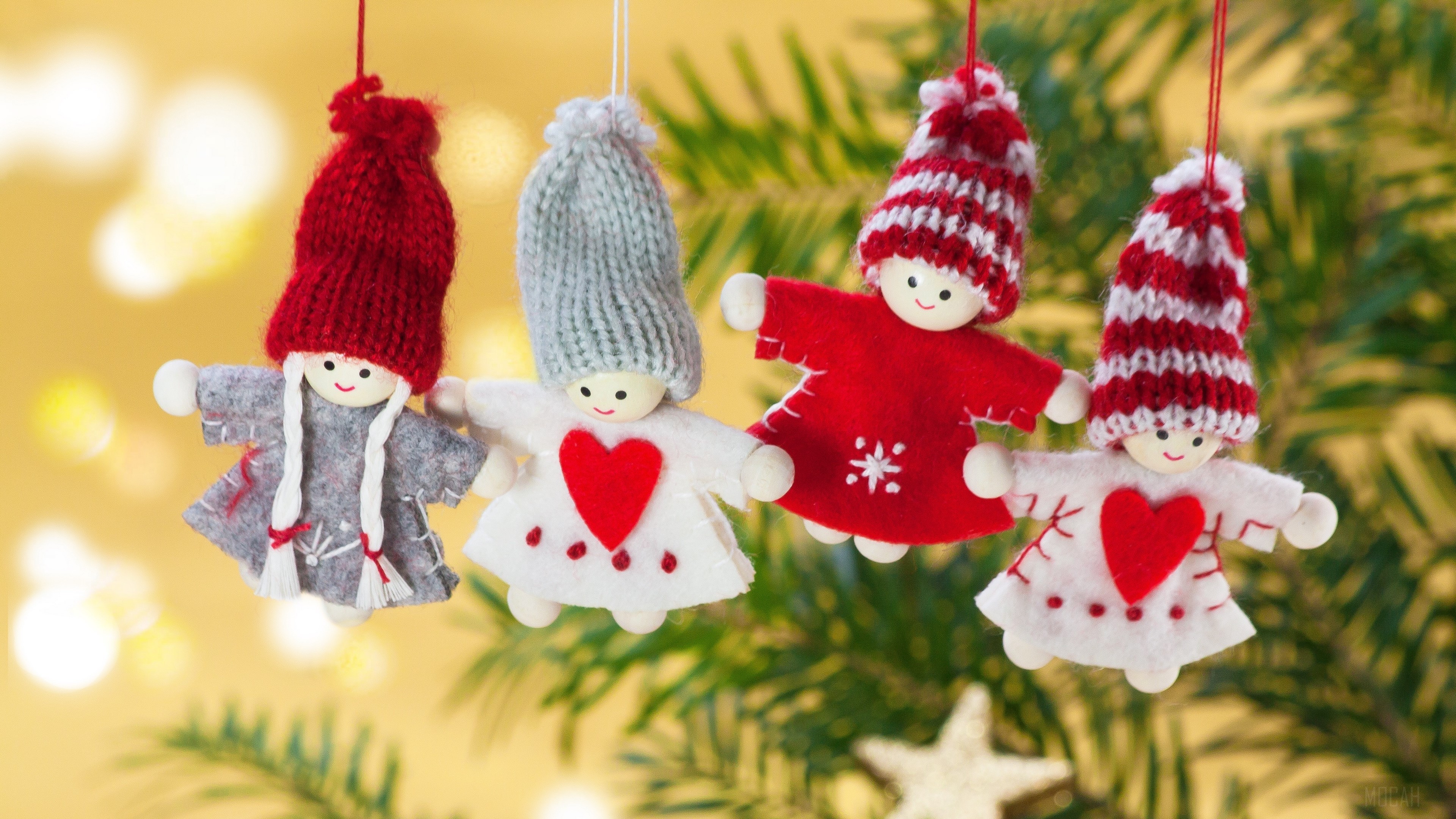 Four Christmas ornaments hanging on a tree branch HD Wallpaper