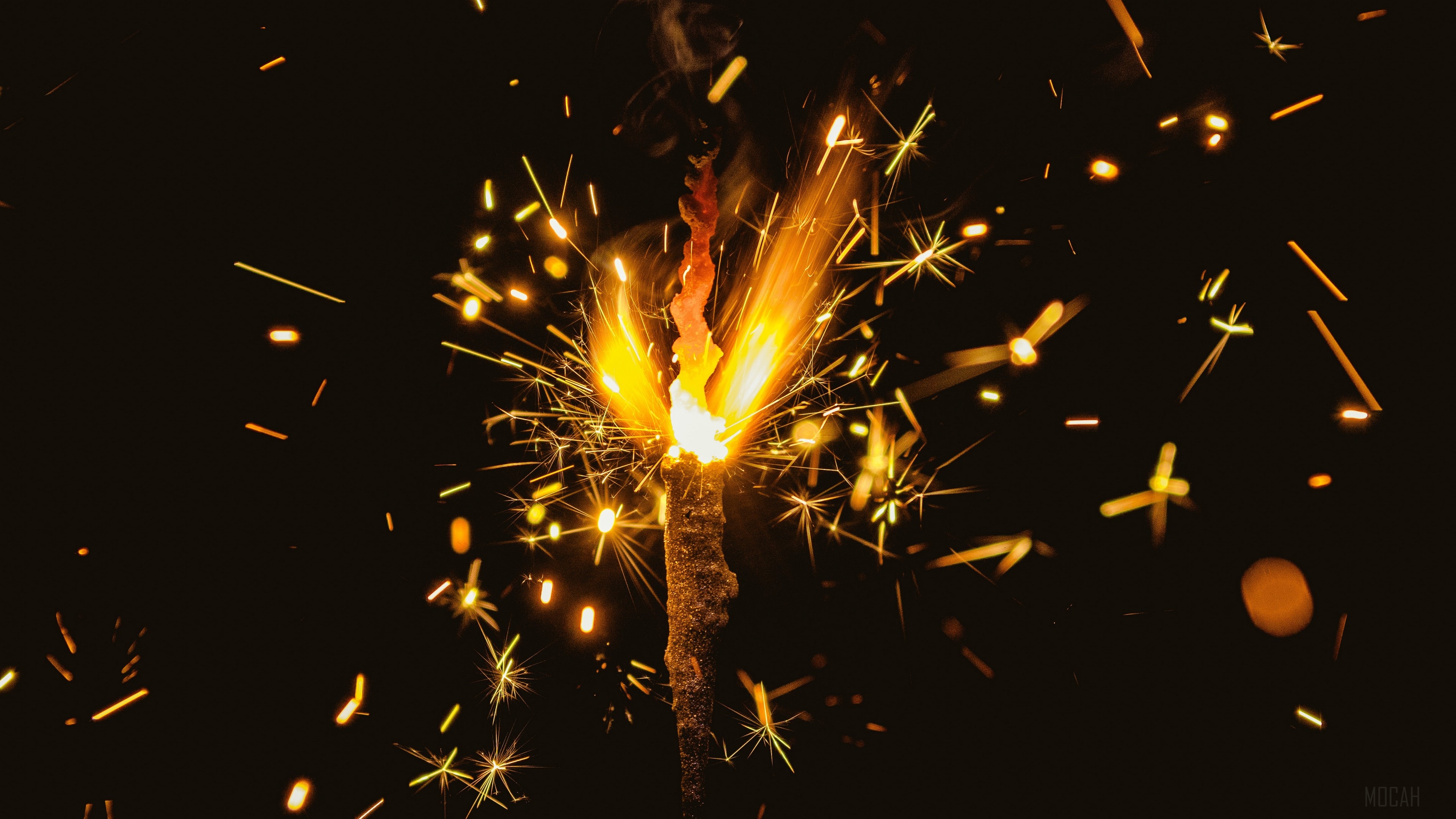 Bengal fire with sparks on dark background 4K HD Wallpaper