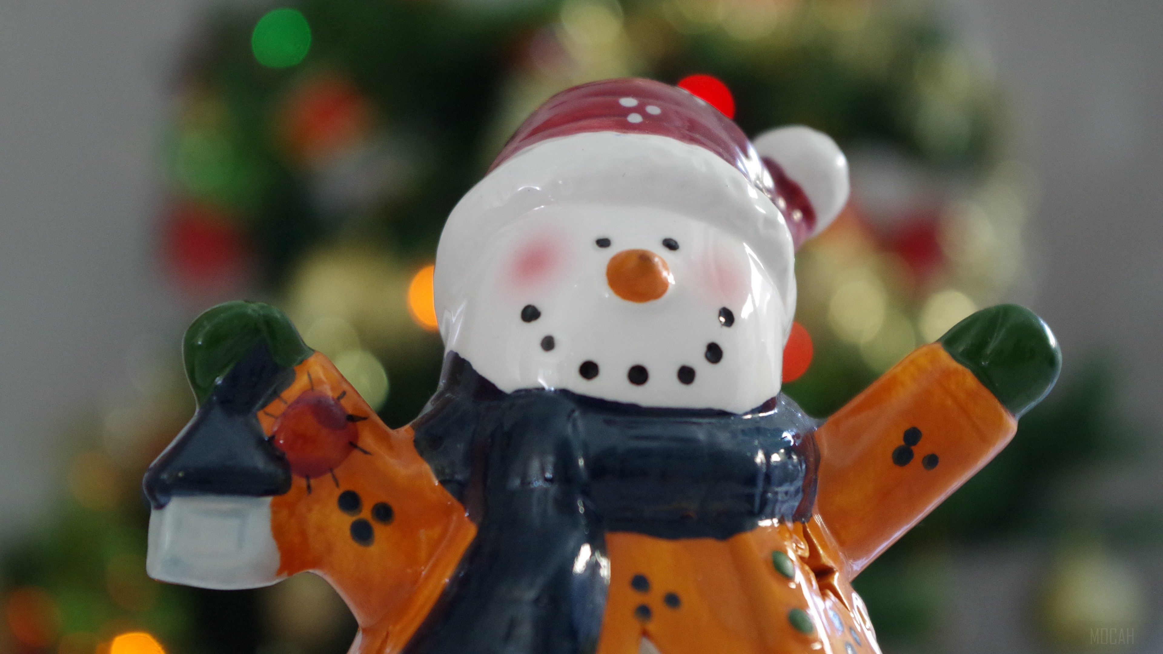 Ceramic Snowman Figurine with Christmas Tree Background 4K HD Wallpaper