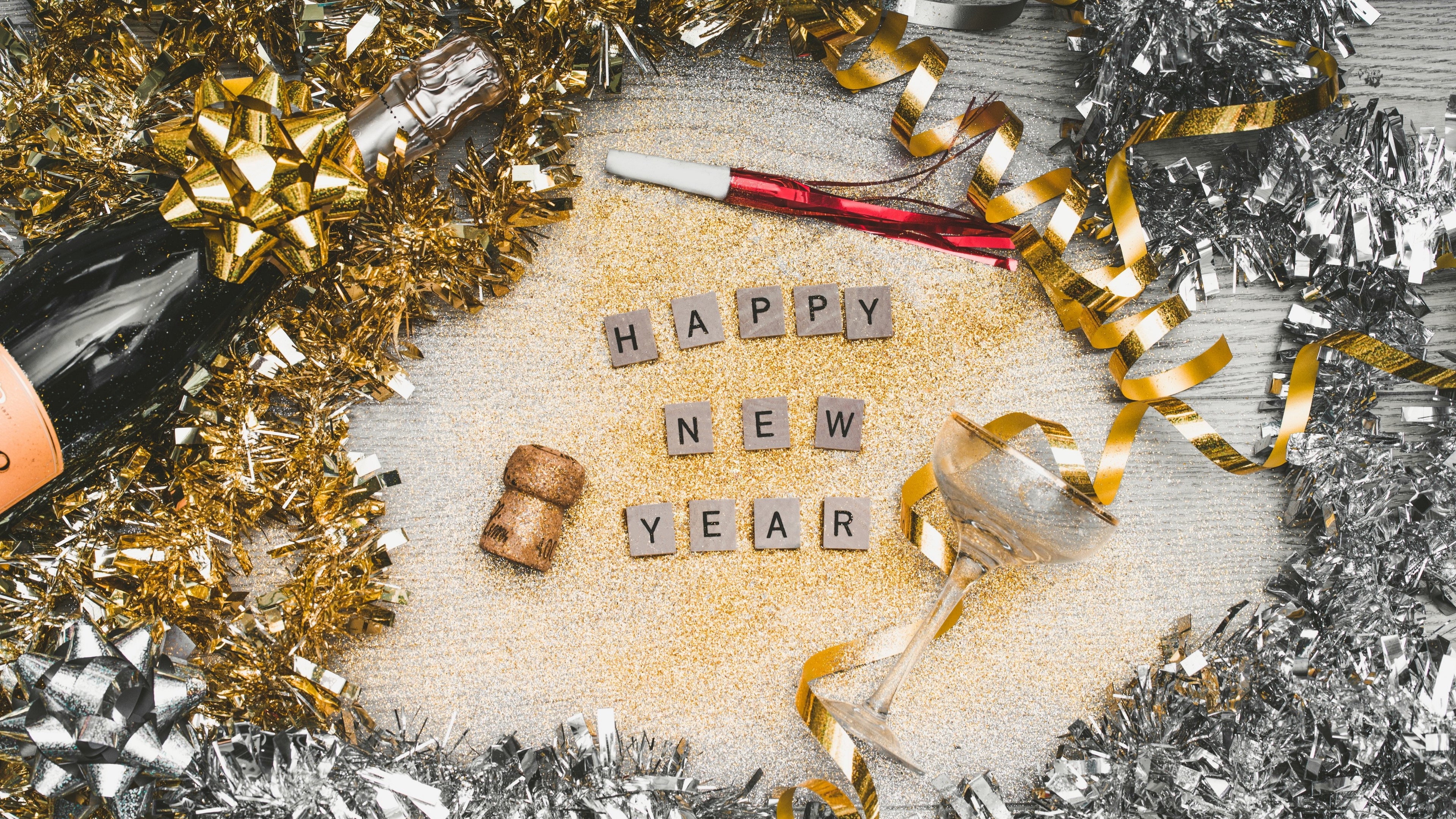 Happy New Year celebration with champagne and confetti 4K HD Wallpaper