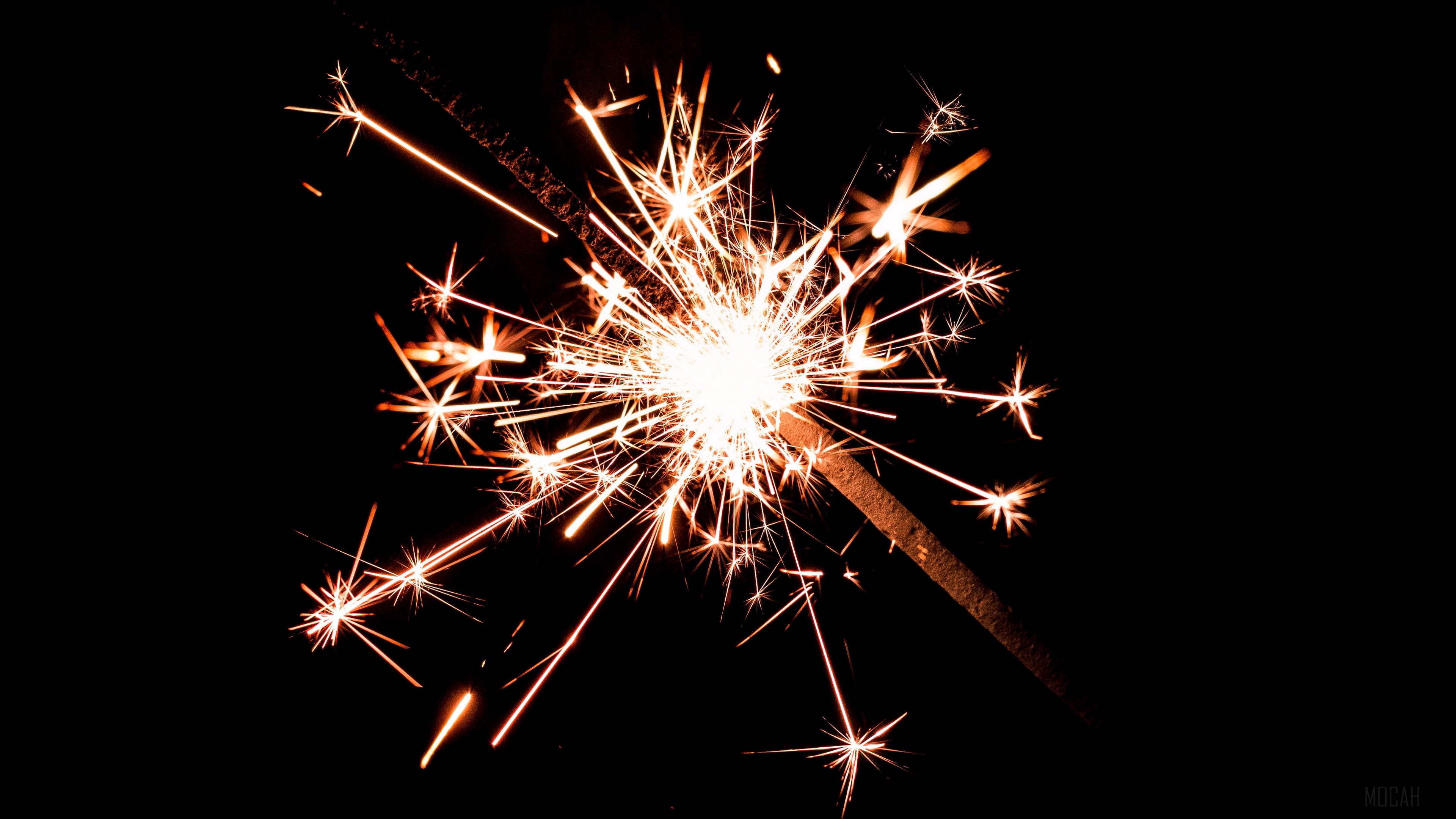 Bengal fire sparks on dark background 4K HD Wallpaper