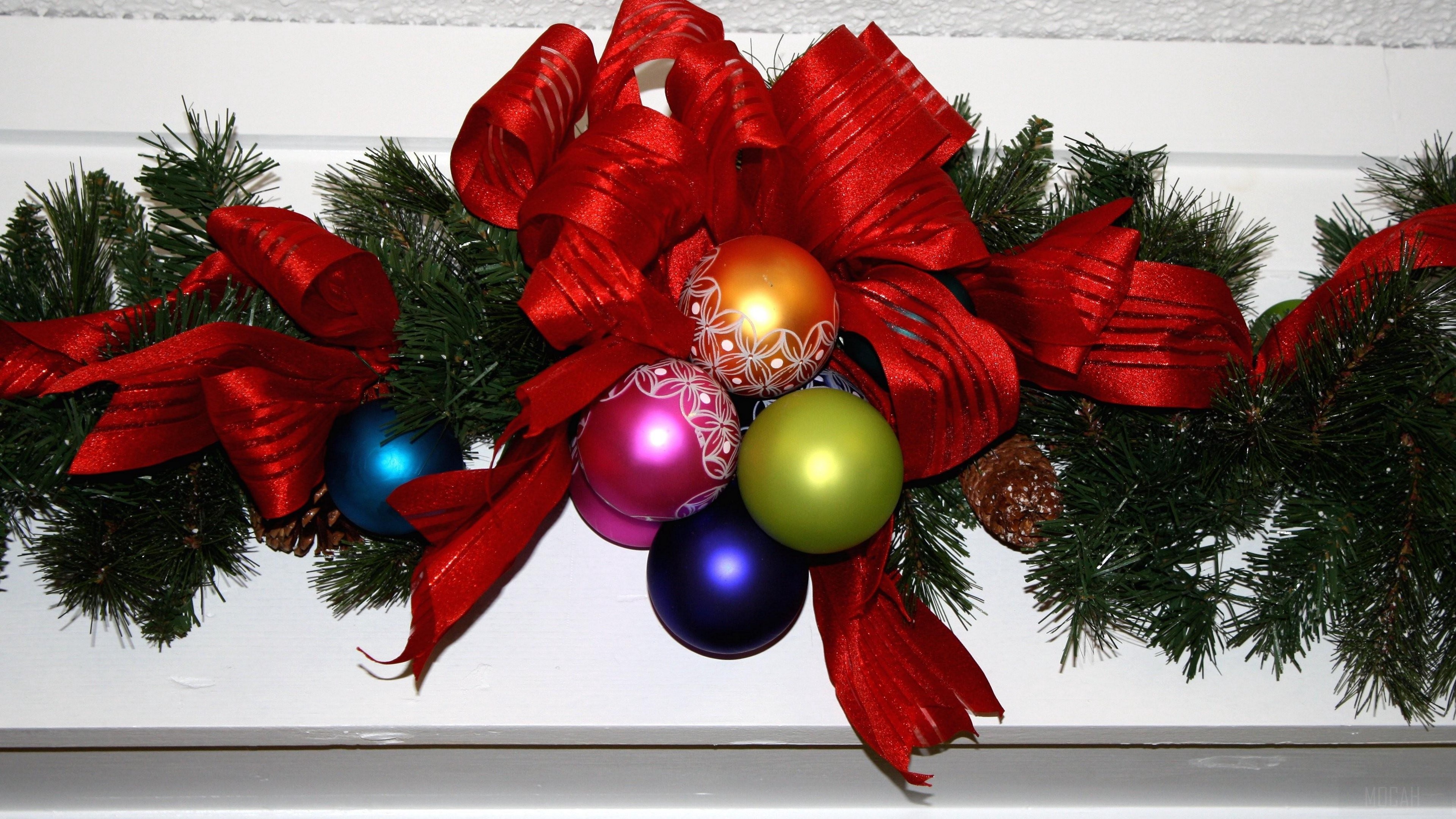 Christmas garland with red ribbon and ornaments 4K HD Wallpaper