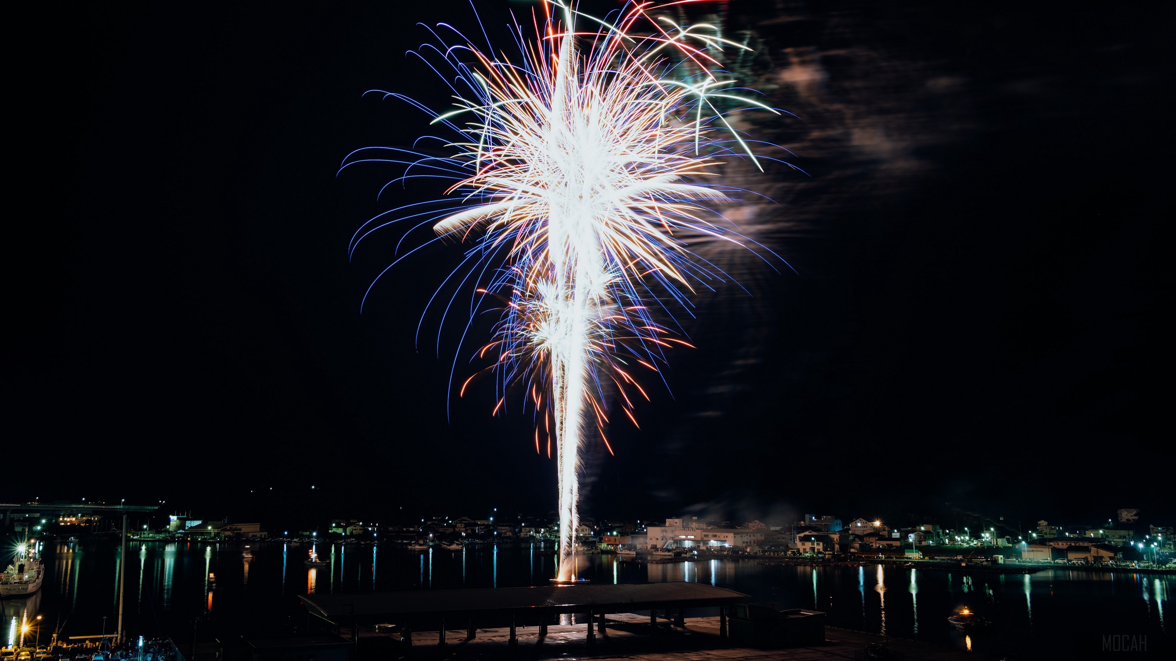 Fireworks over a night city harbor HD Wallpaper