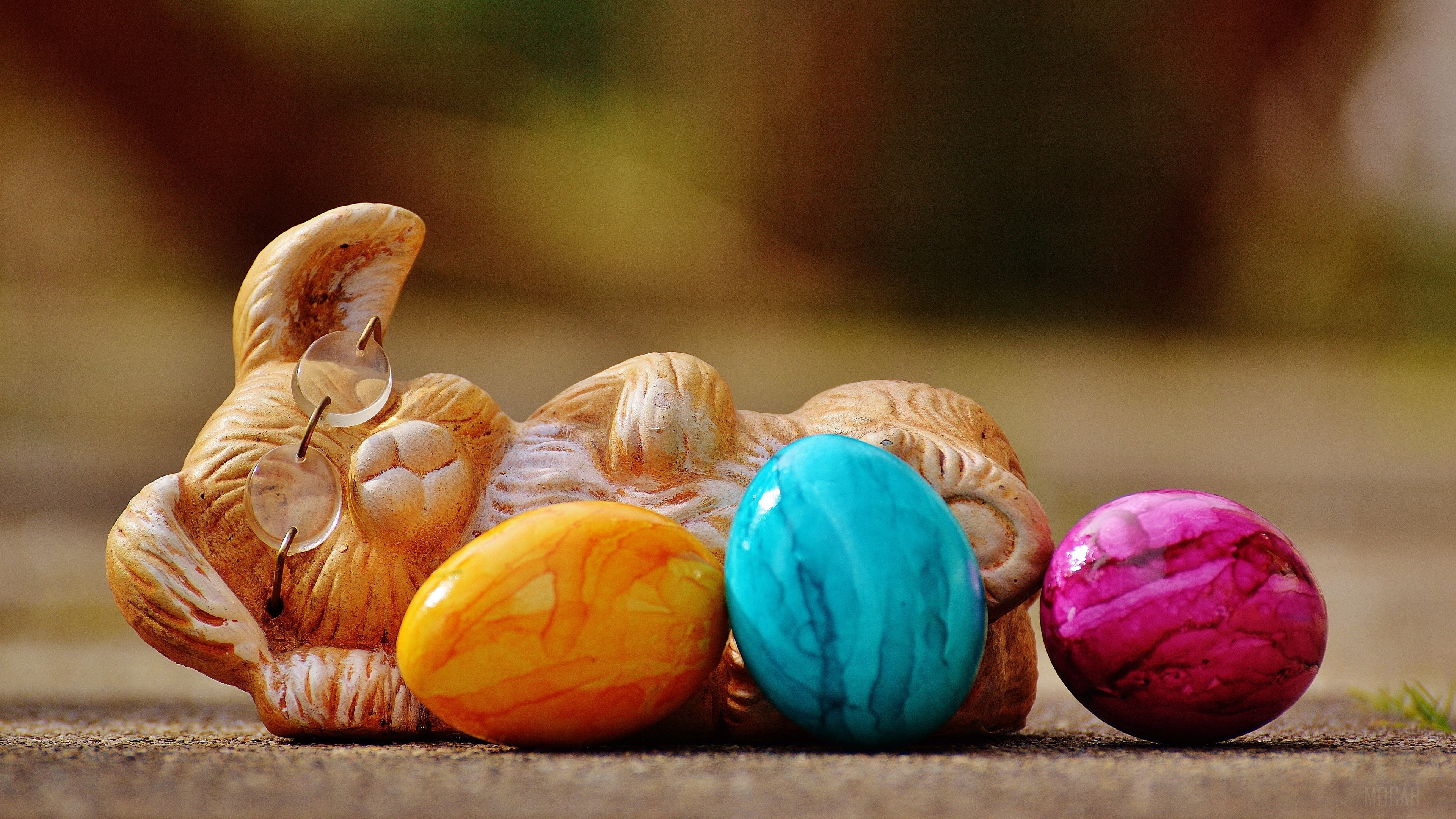 Easter bunny figurine with colorful eggs 4K HD Wallpaper