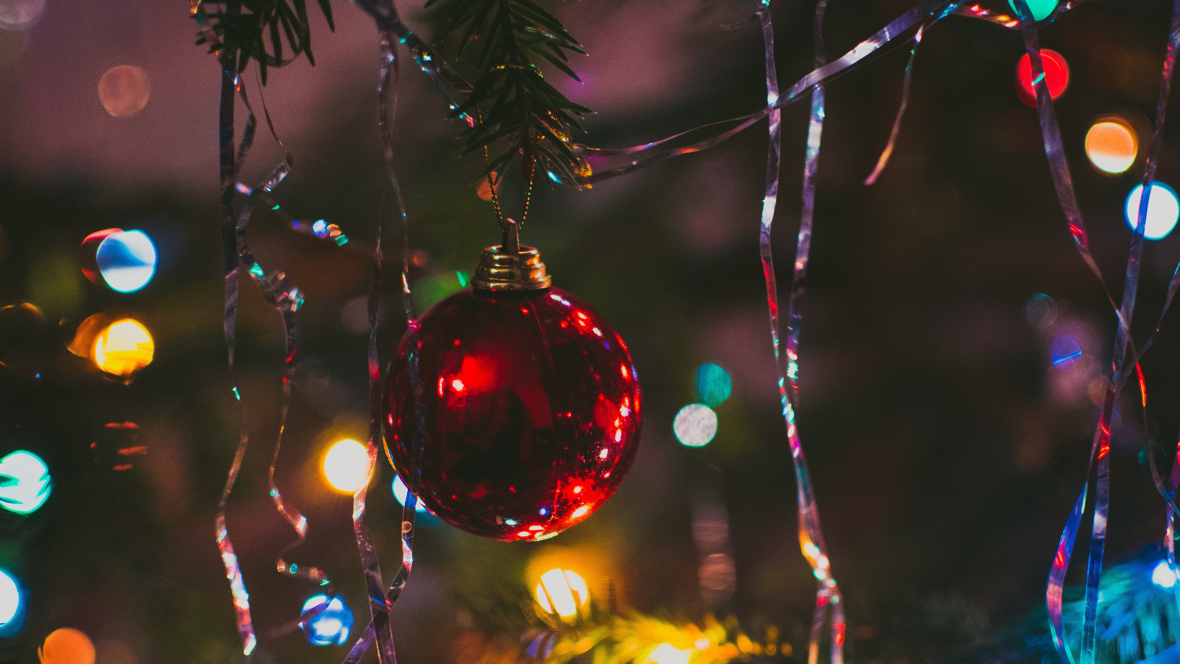 Red Christmas ornament on a tree with lights HD Wallpaper