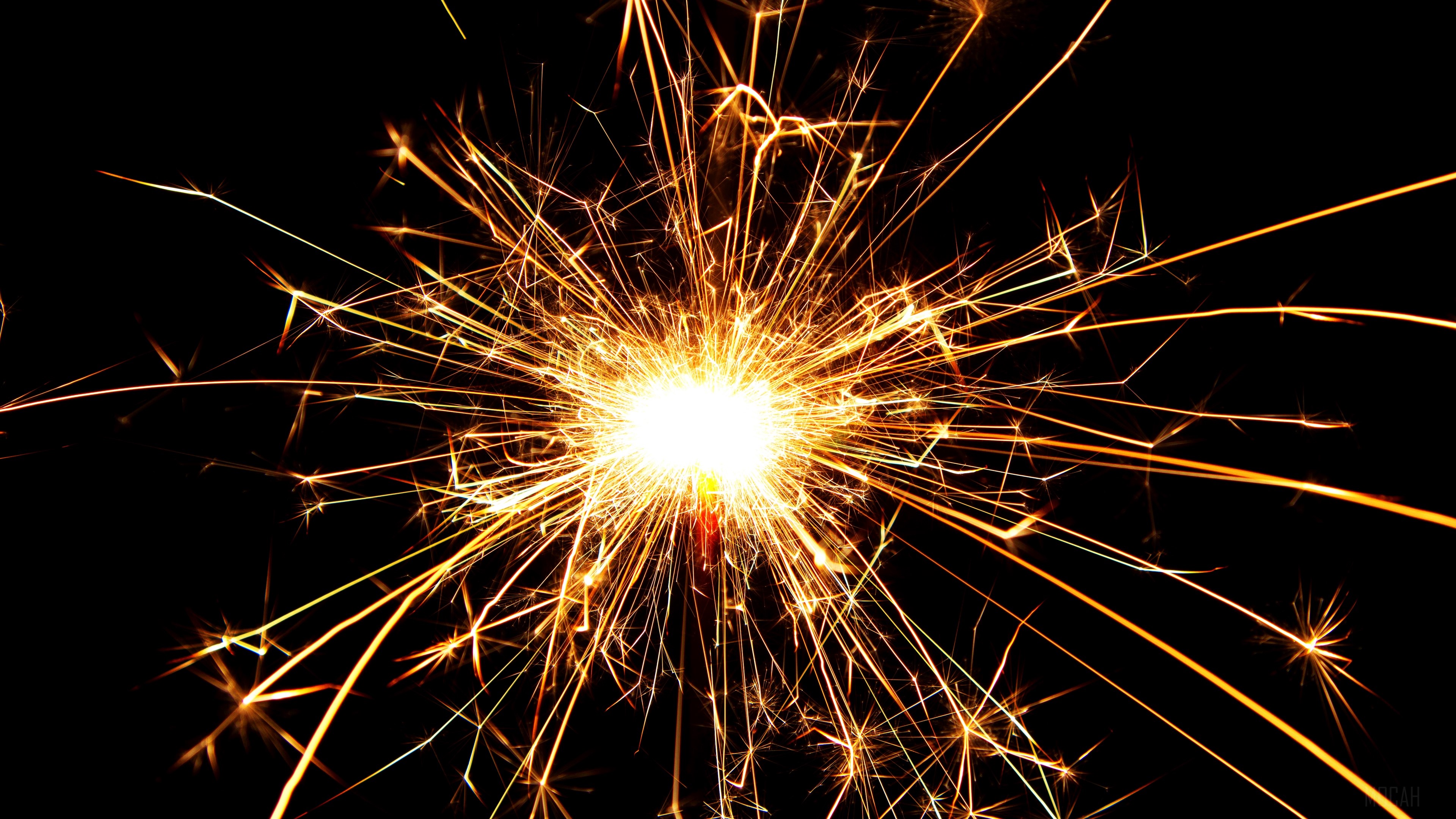 Sparkler with bright sparks on black background 4K HD Wallpaper