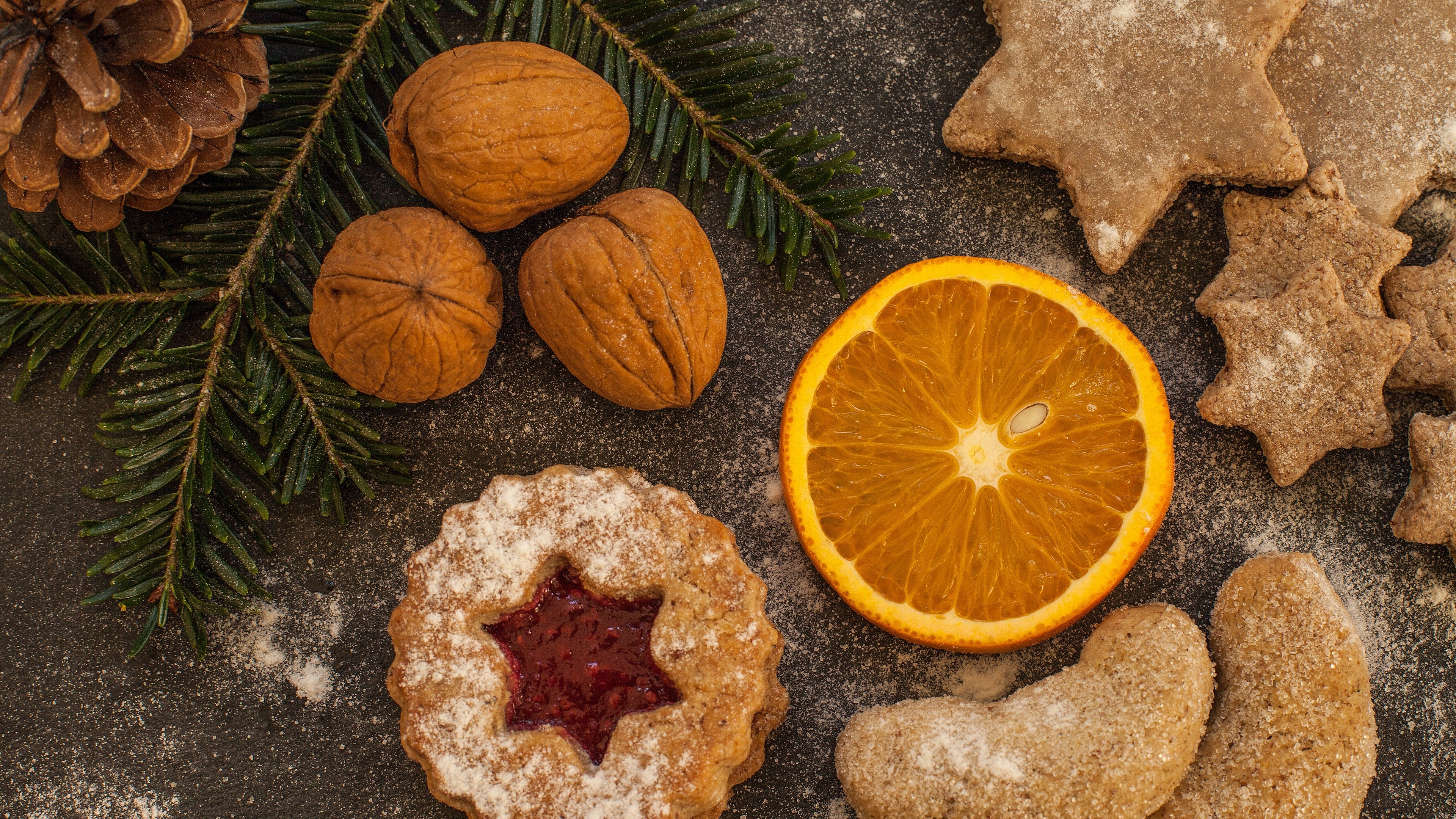 Christmas cookies with walnuts, pine cone, and orange slice 4K HD Wallpaper