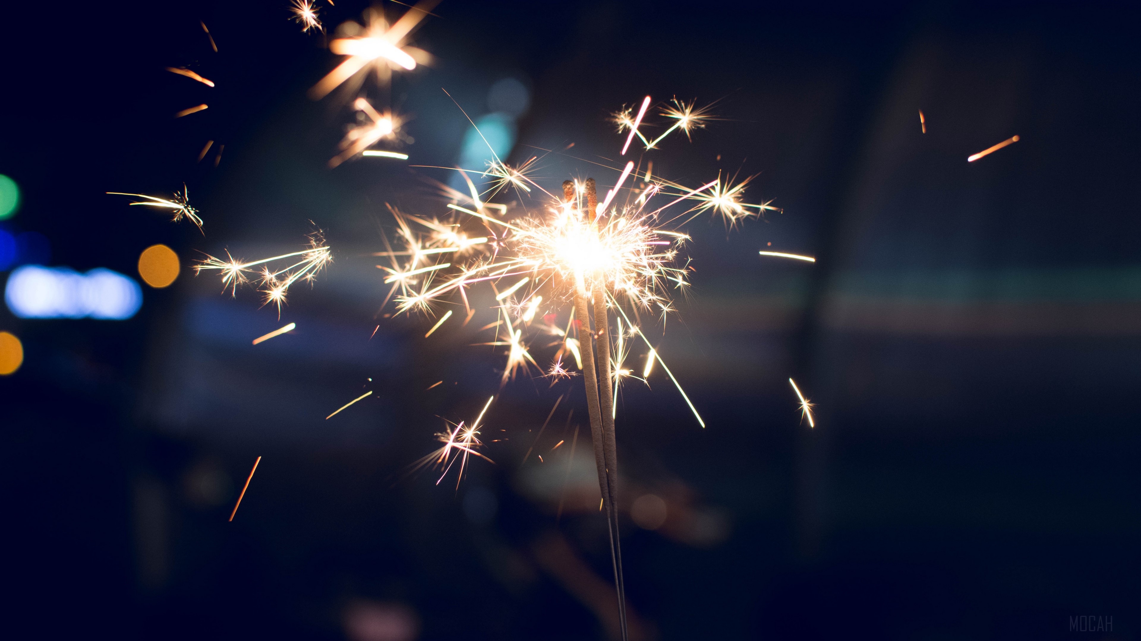 Sparkler with sparks and bokeh lights HD Wallpaper