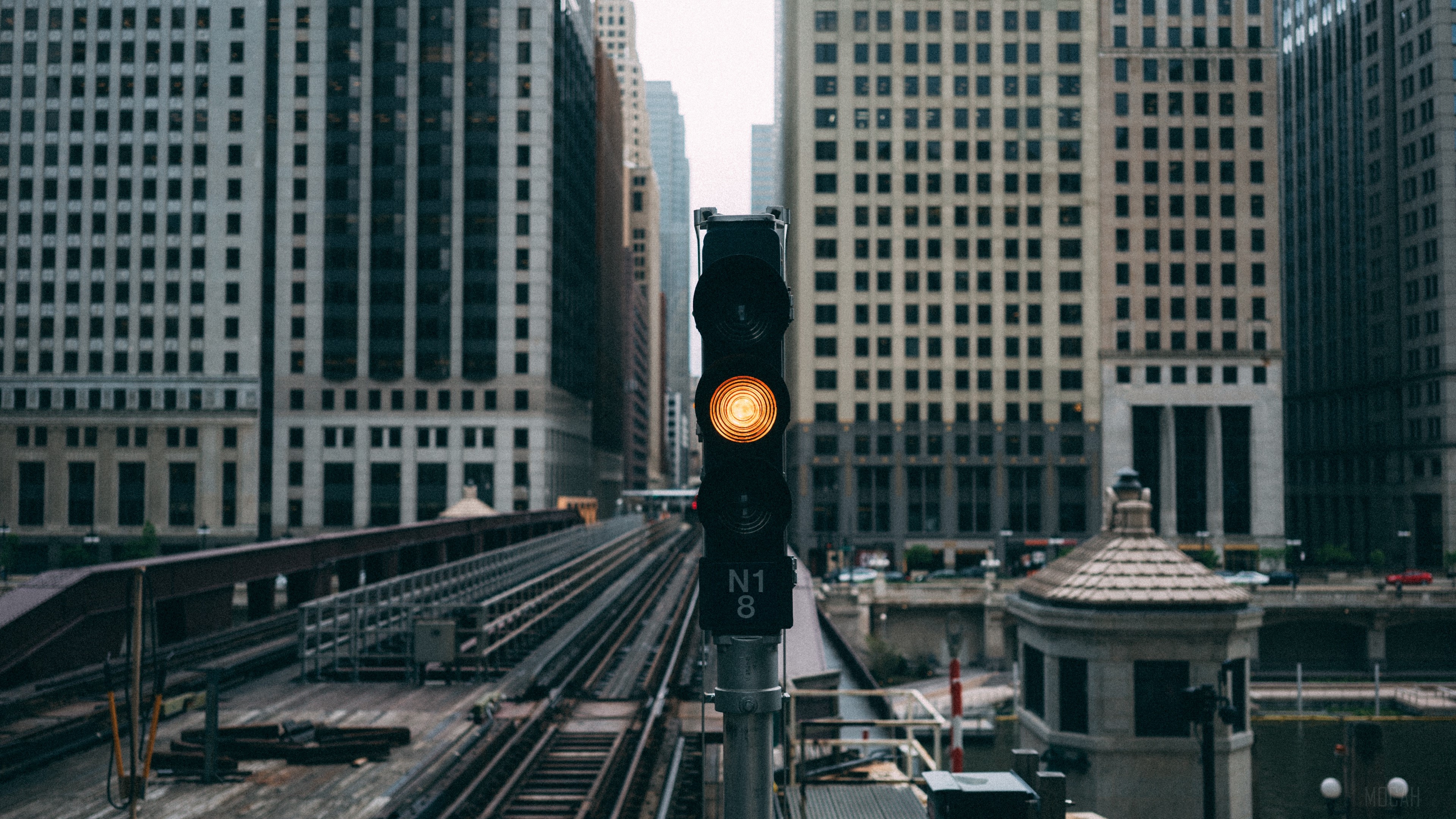 Traffic light in a city with buildings HD Wallpaper
