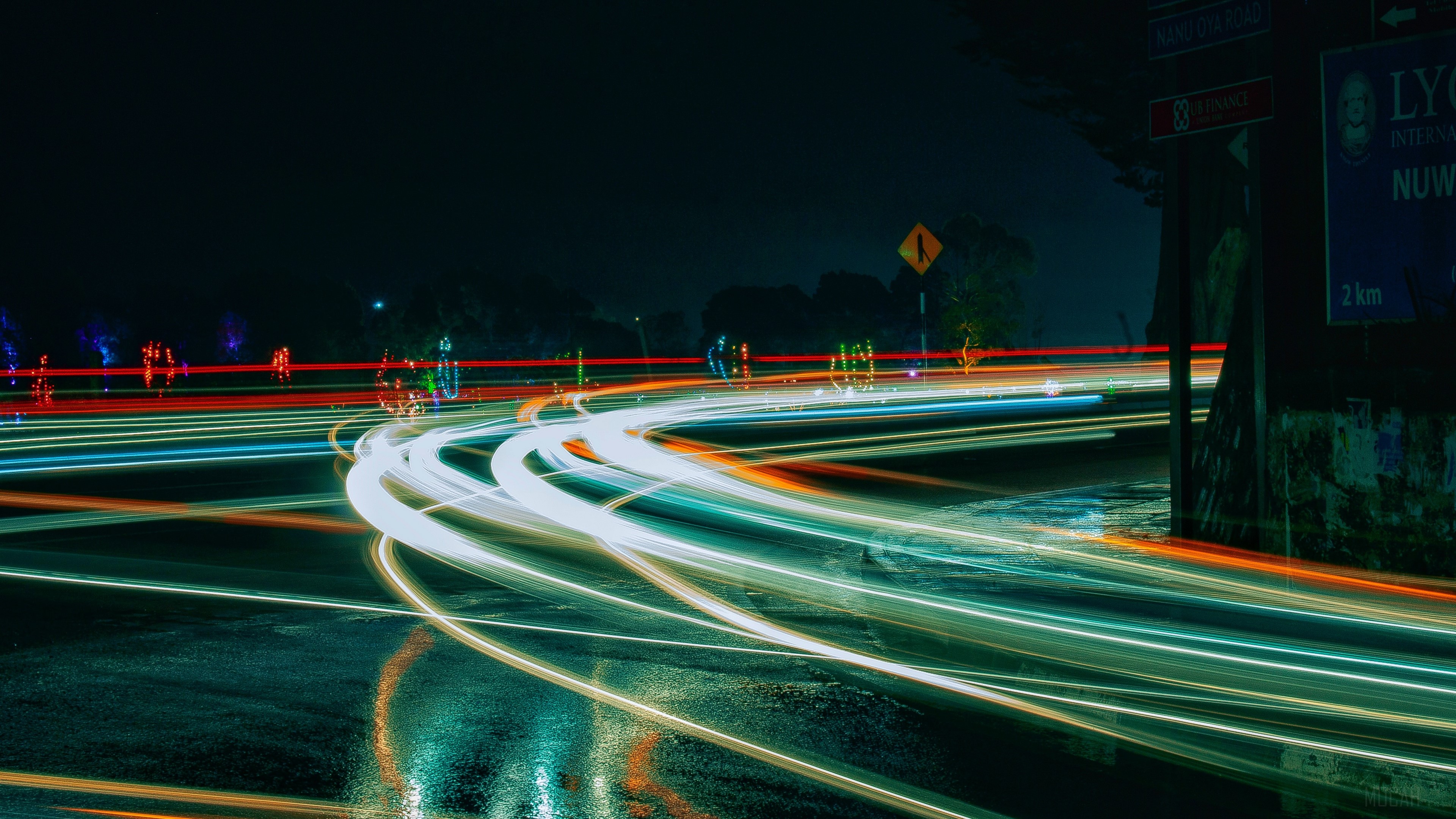 Light trails on a wet road at night HD Wallpaper