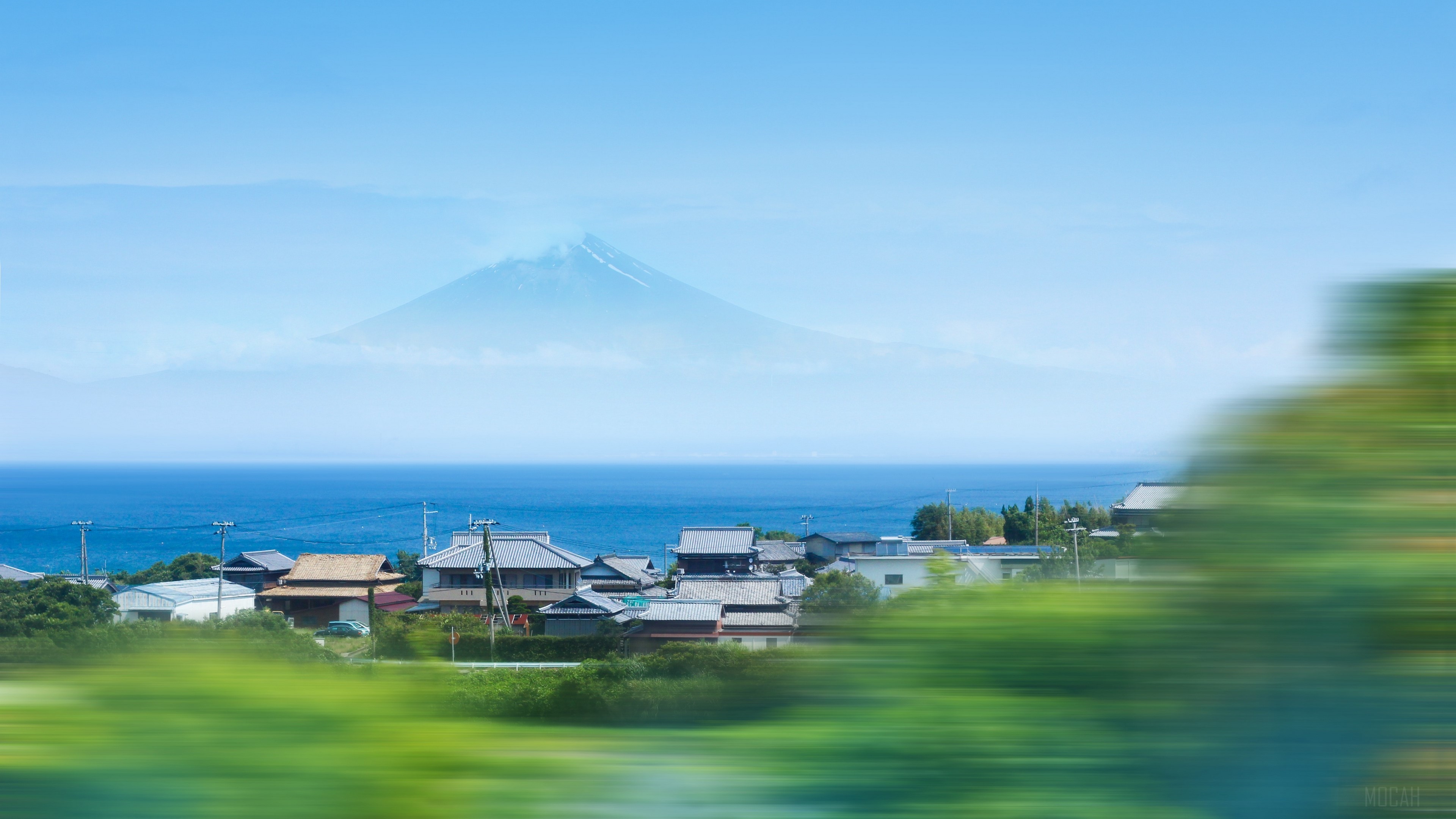 Mount Fuji over coastal village with motion blur HD Wallpaper