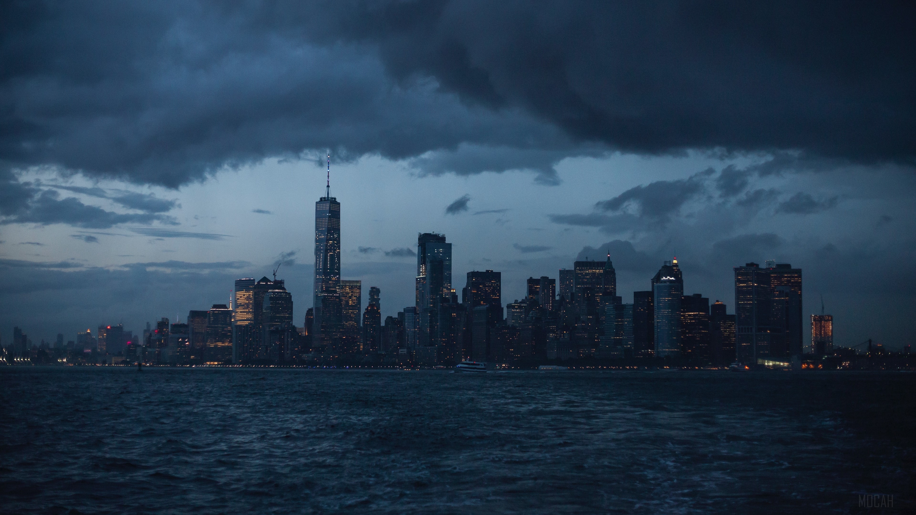 New York City skyline at night over the sea HD Wallpaper