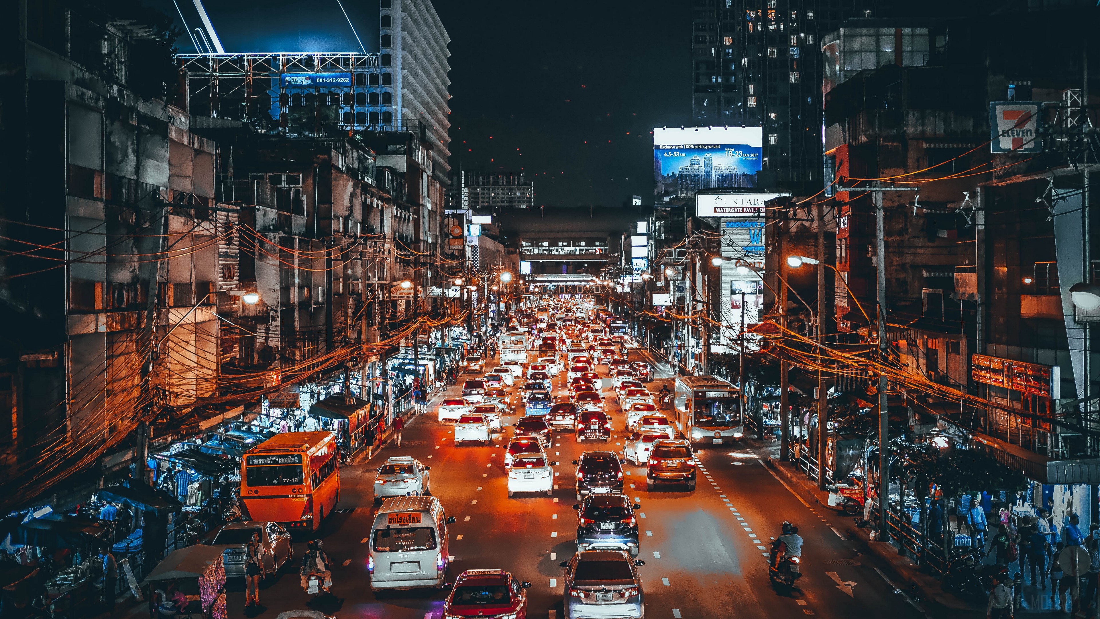 Busy street traffic at night in a city HD Wallpaper