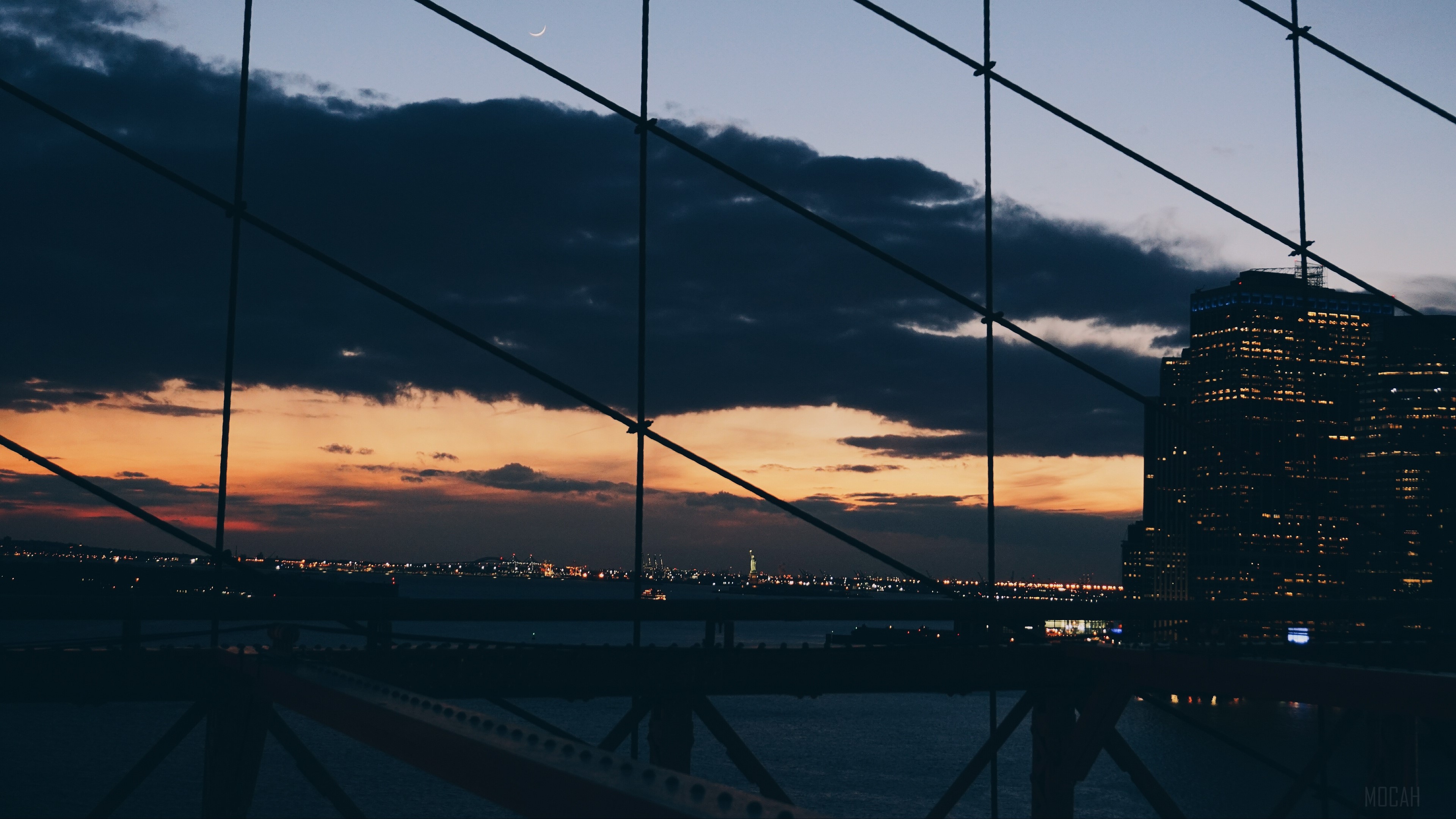 New York City skyline at dusk through bridge mesh 4K HD Wallpaper
