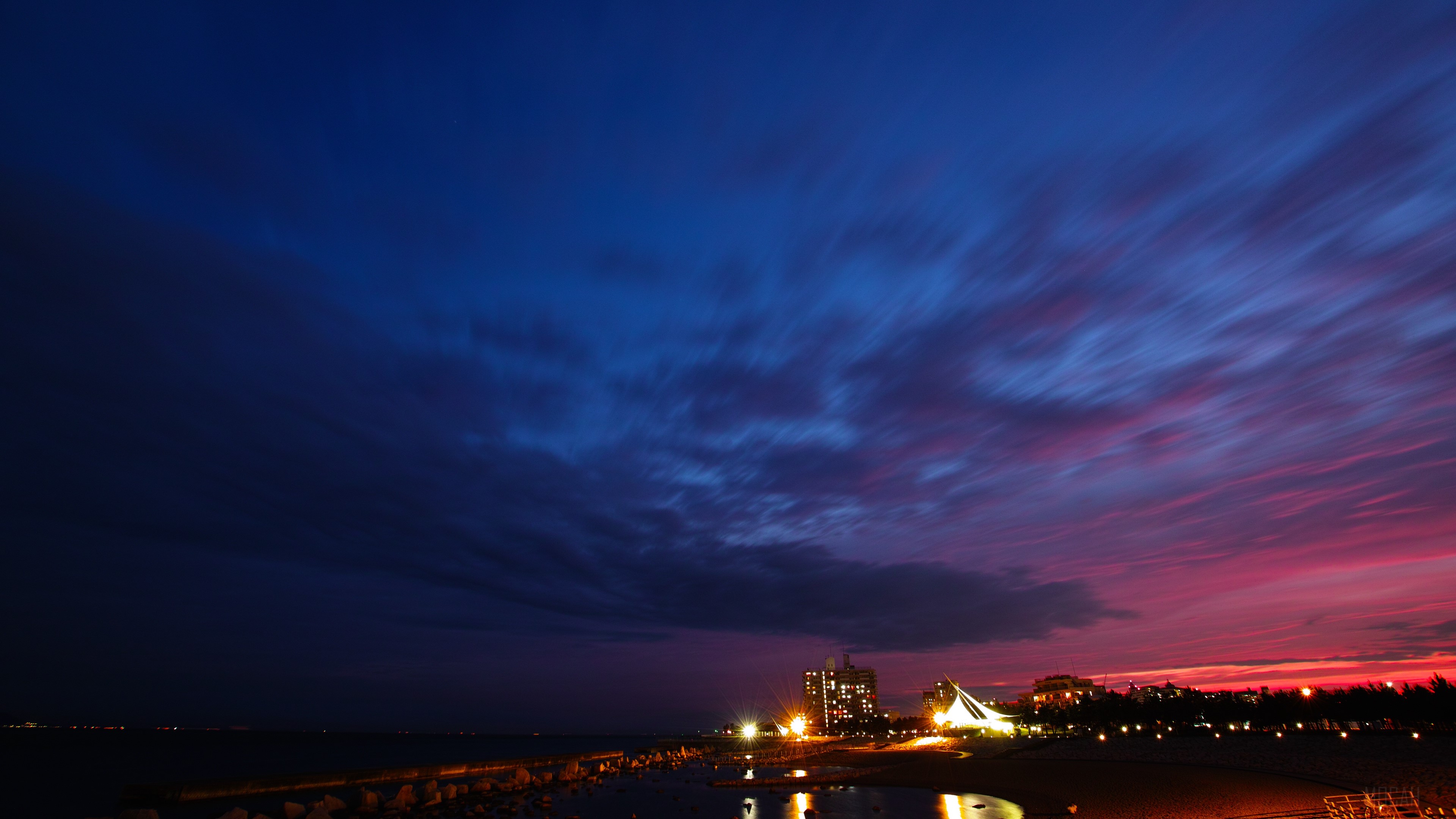 Night city with colorful clouds over the ocean HD Wallpaper