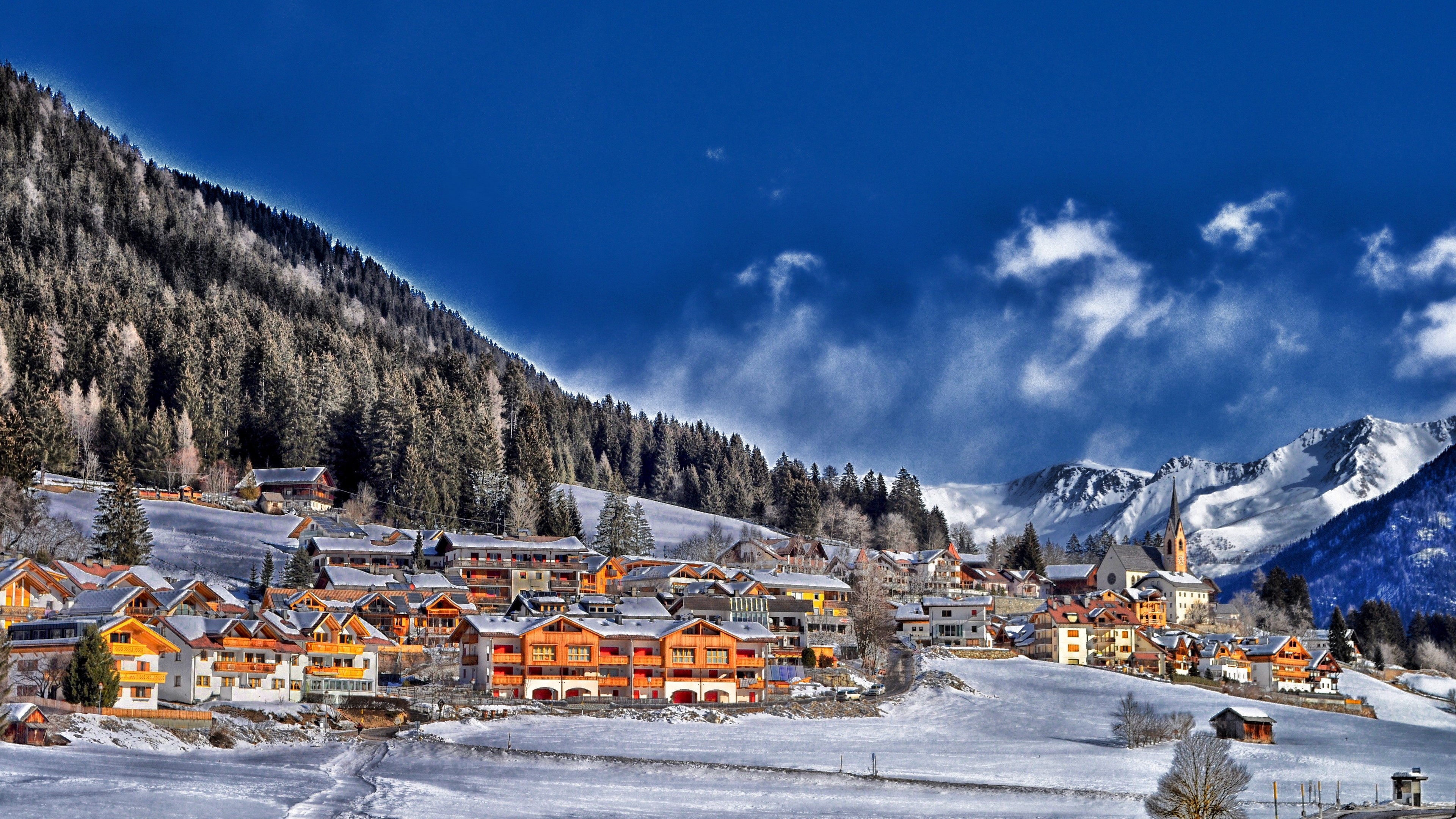 Winter village in the Alps with snow-covered mountains HD Wallpaper