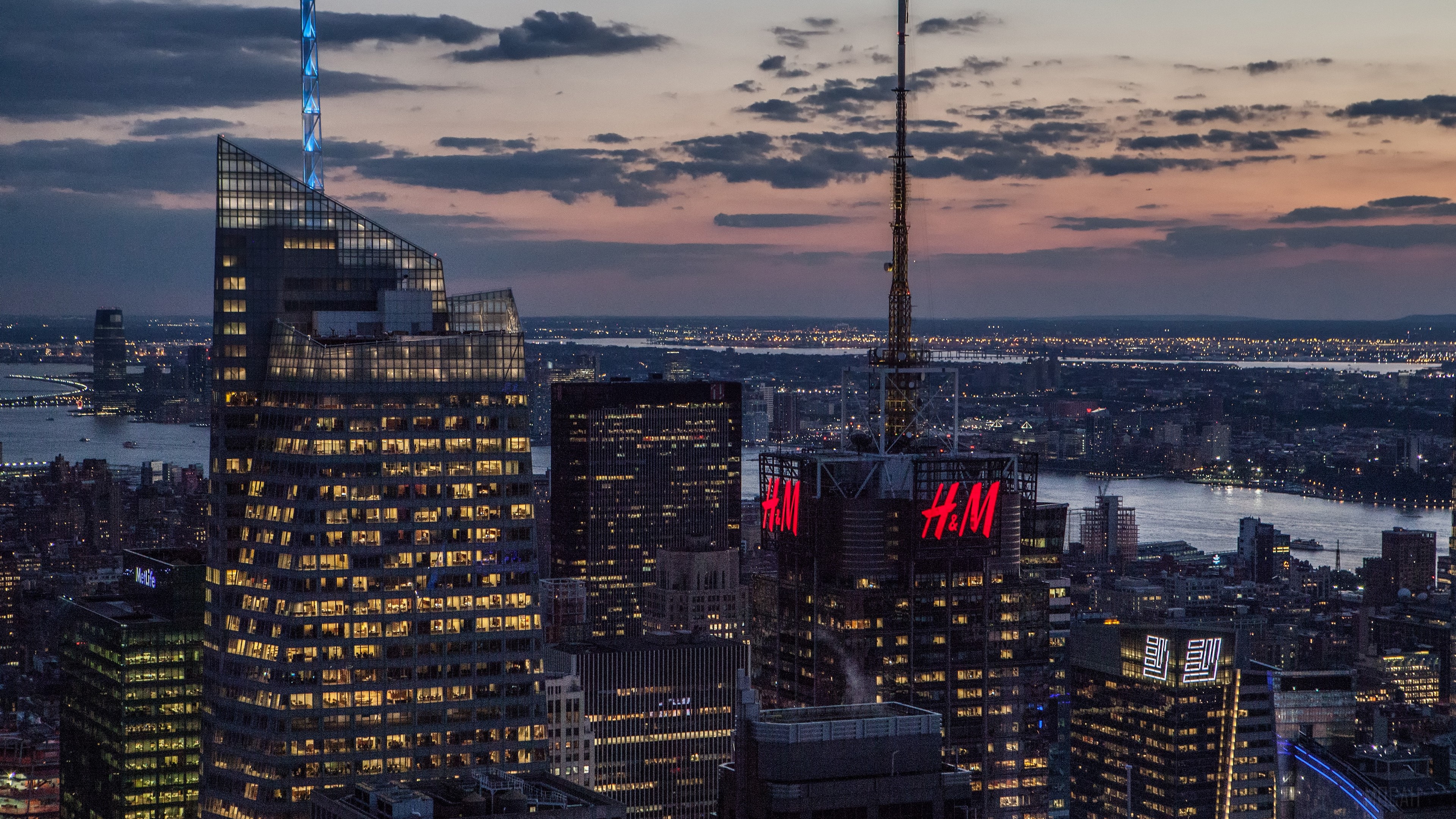 New York City skyscrapers at dusk with H&M signs HD Wallpaper