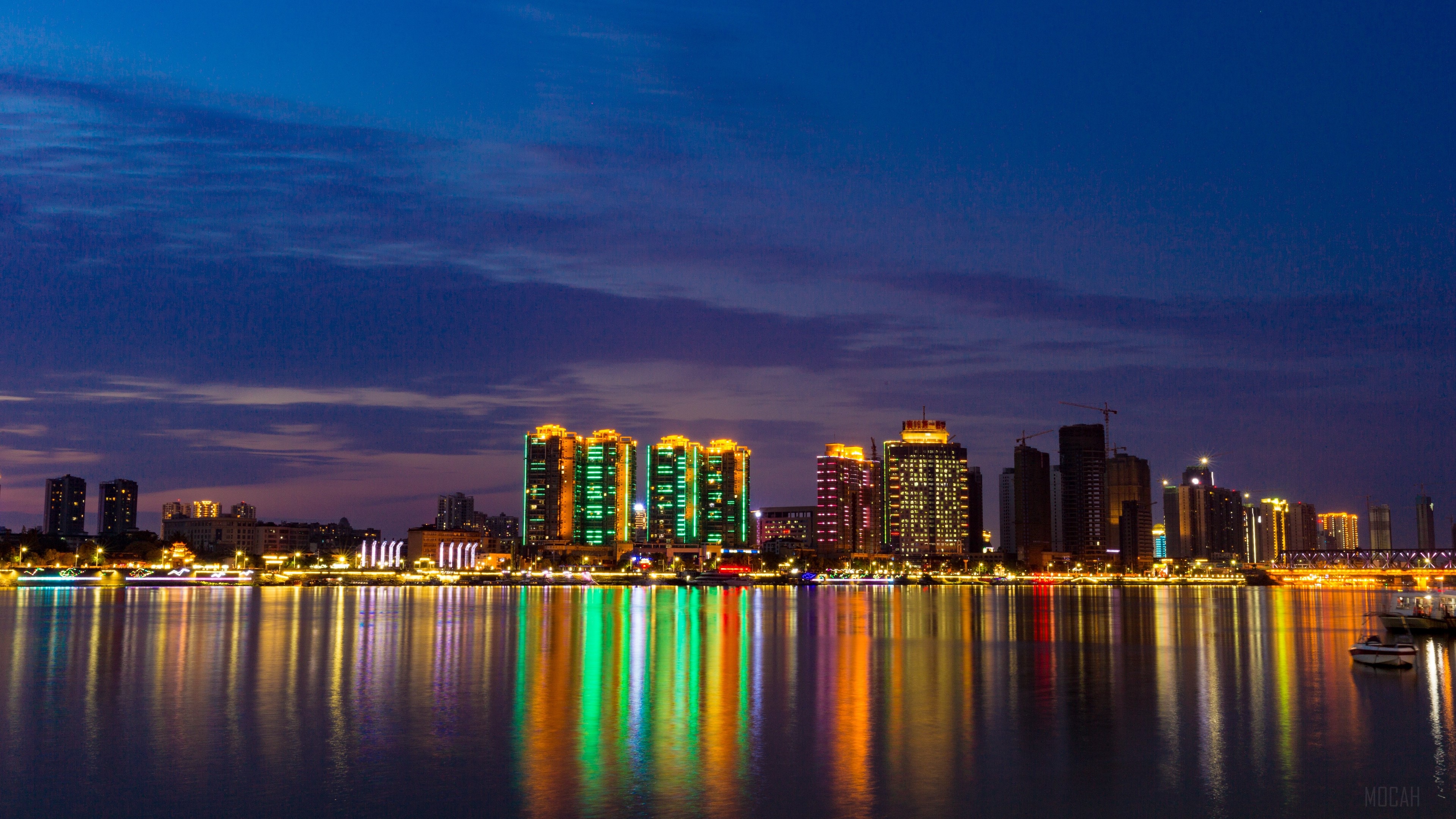 Night city panorama with illuminated skyscrapers and reflections HD Wallpaper