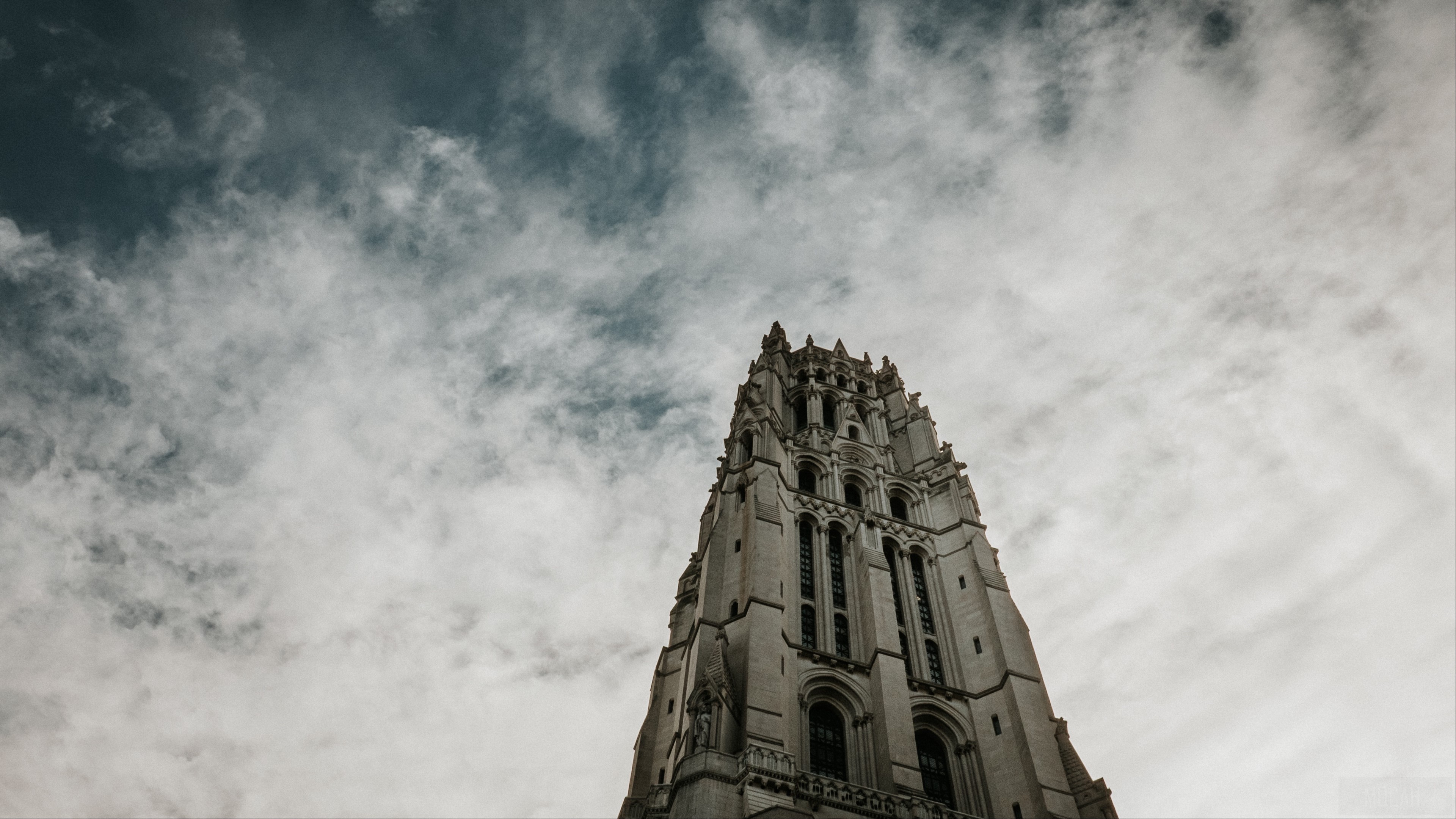Gothic architecture tower against a cloudy sky HD Wallpaper