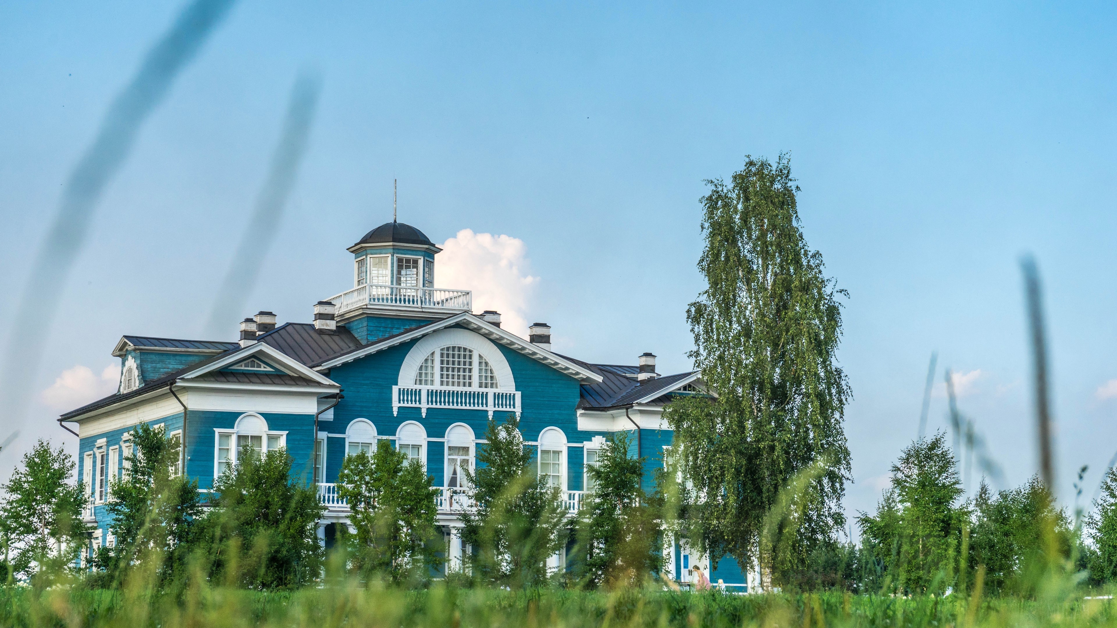 Blue house with a tower and trees HD Wallpaper