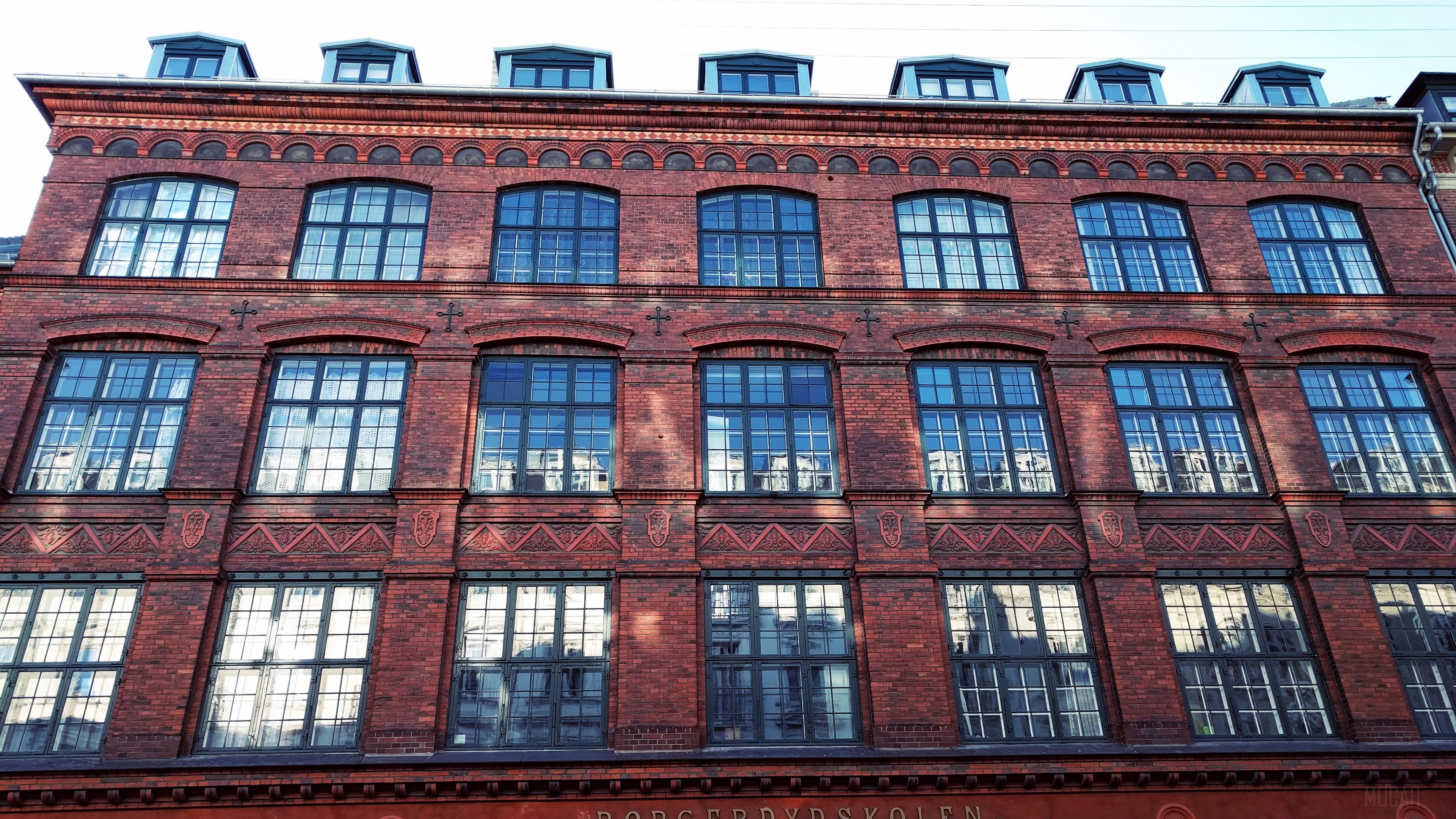 Brick building facade with multiple windows 4K HD Wallpaper