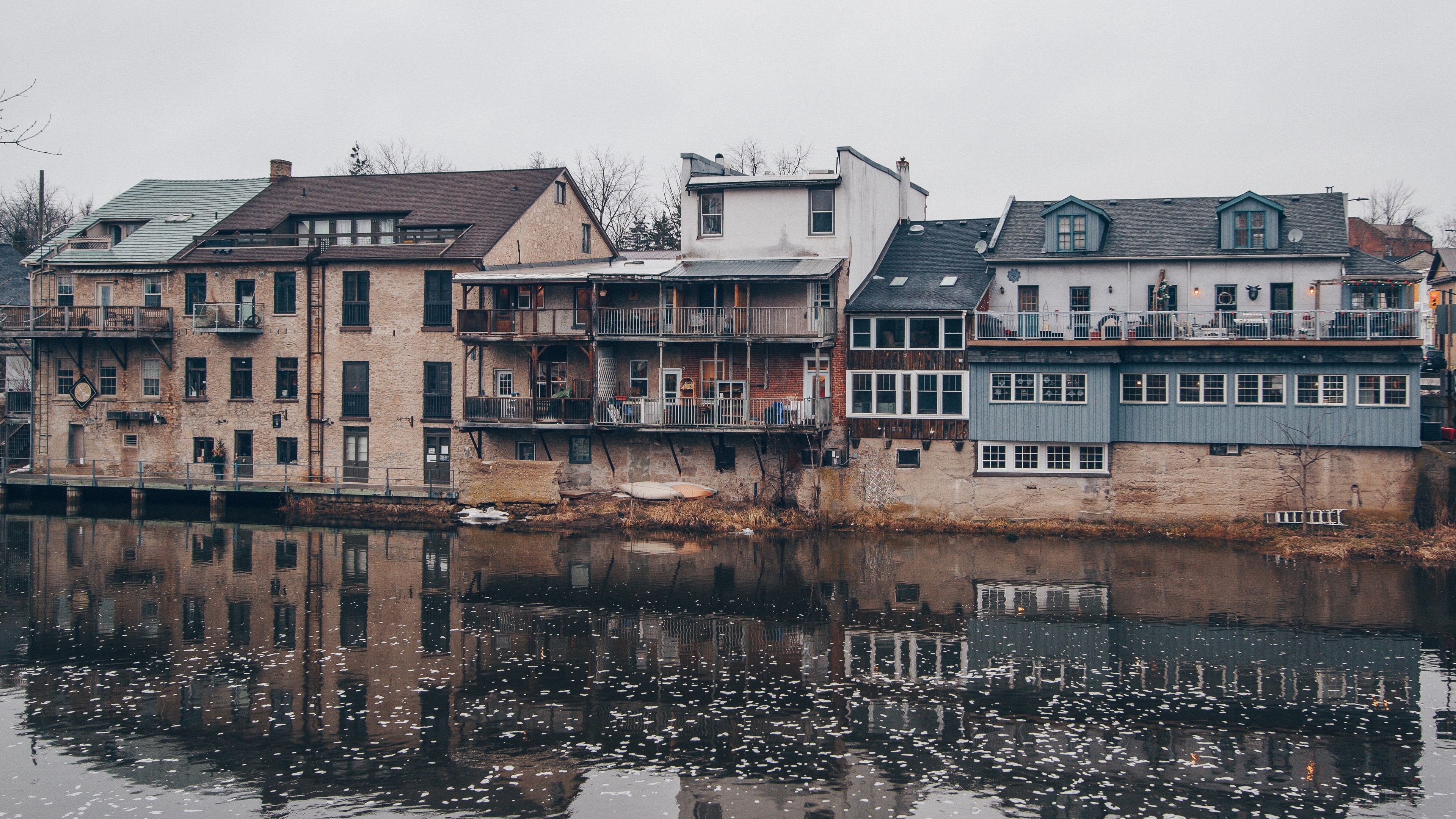 Buildings on a river with reflections 4K HD Wallpaper