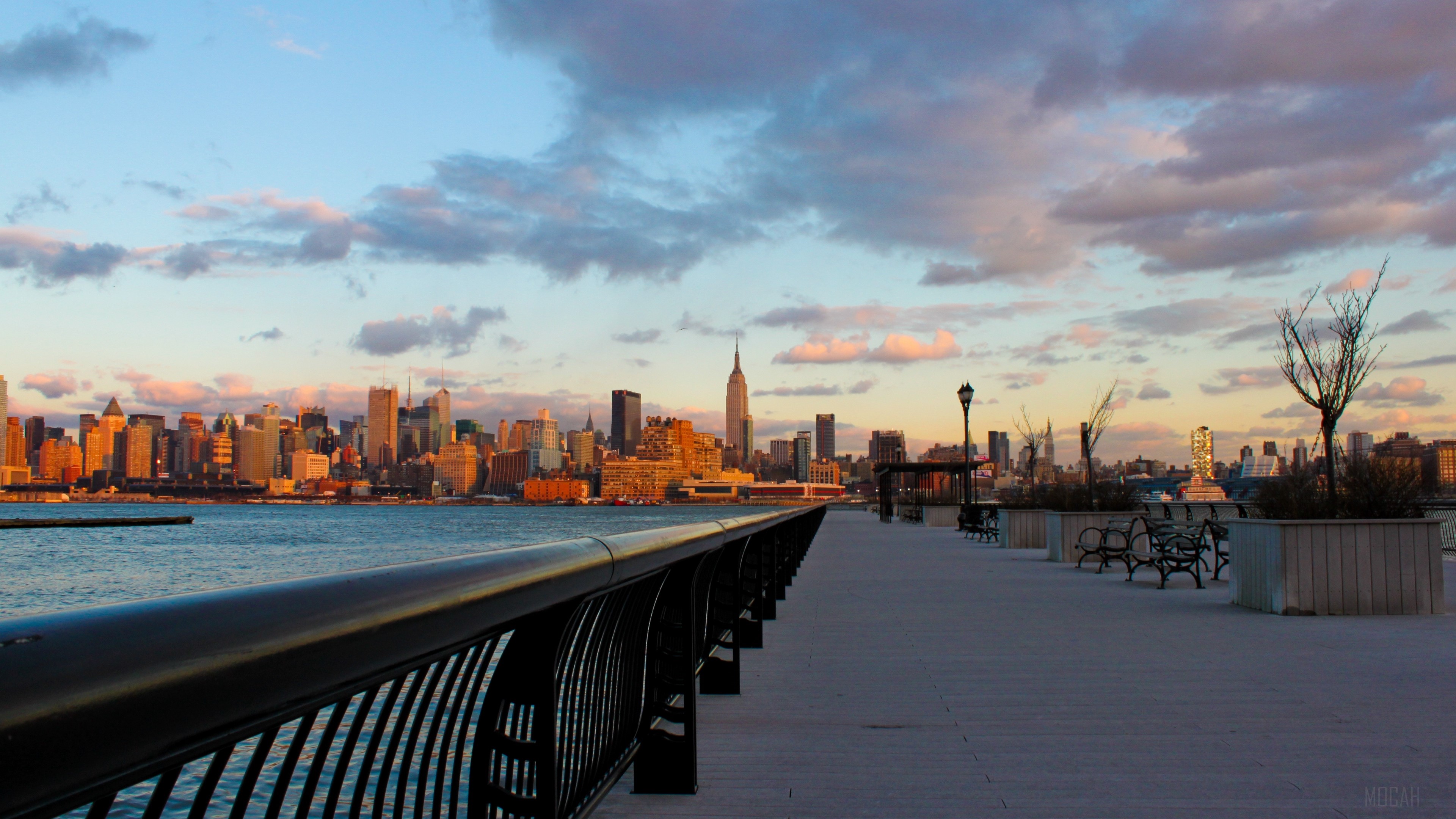 New York City skyline at sunset from an embankment HD Wallpaper