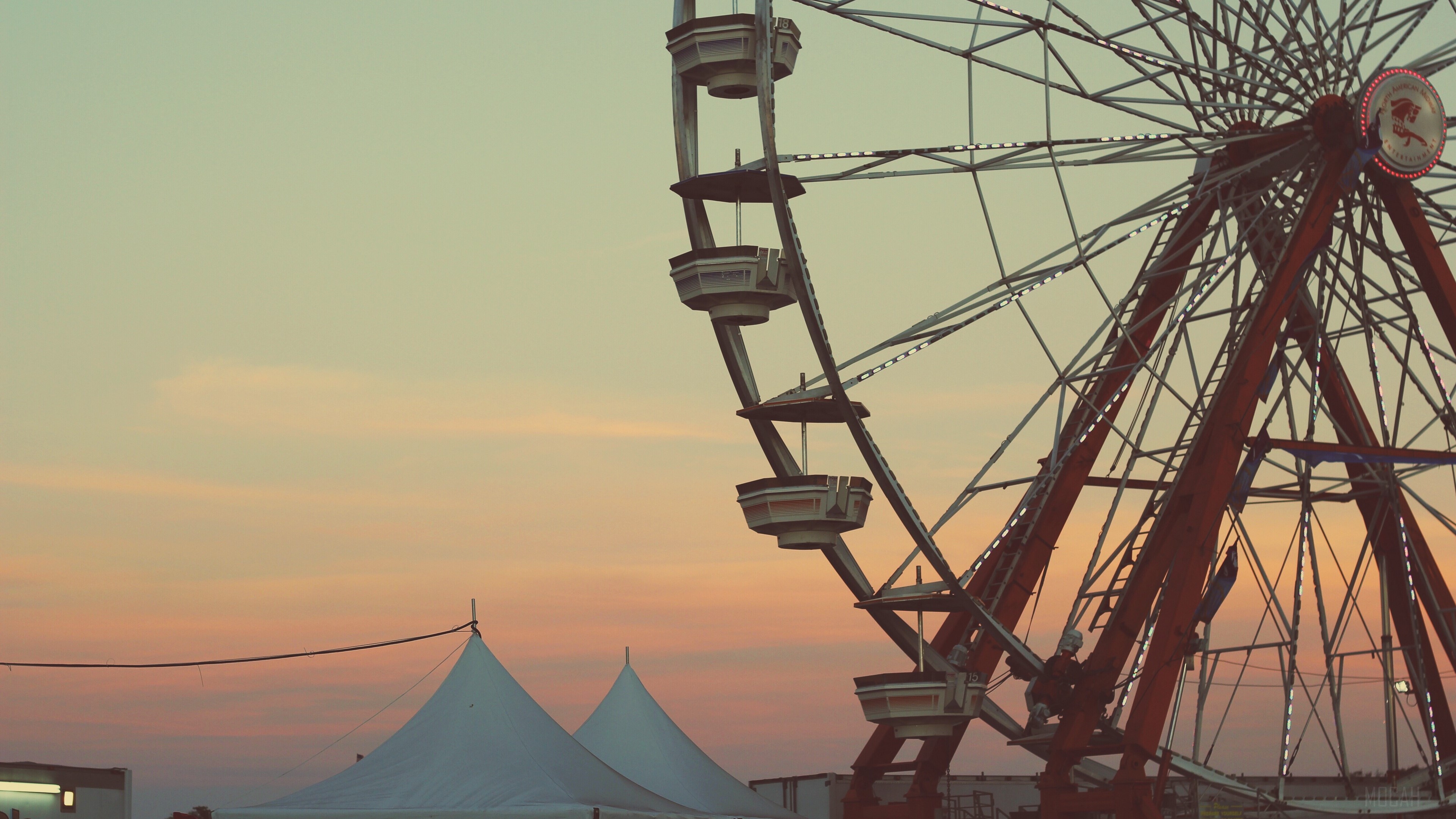 Ferris wheel at sunset with tents HD Wallpaper
