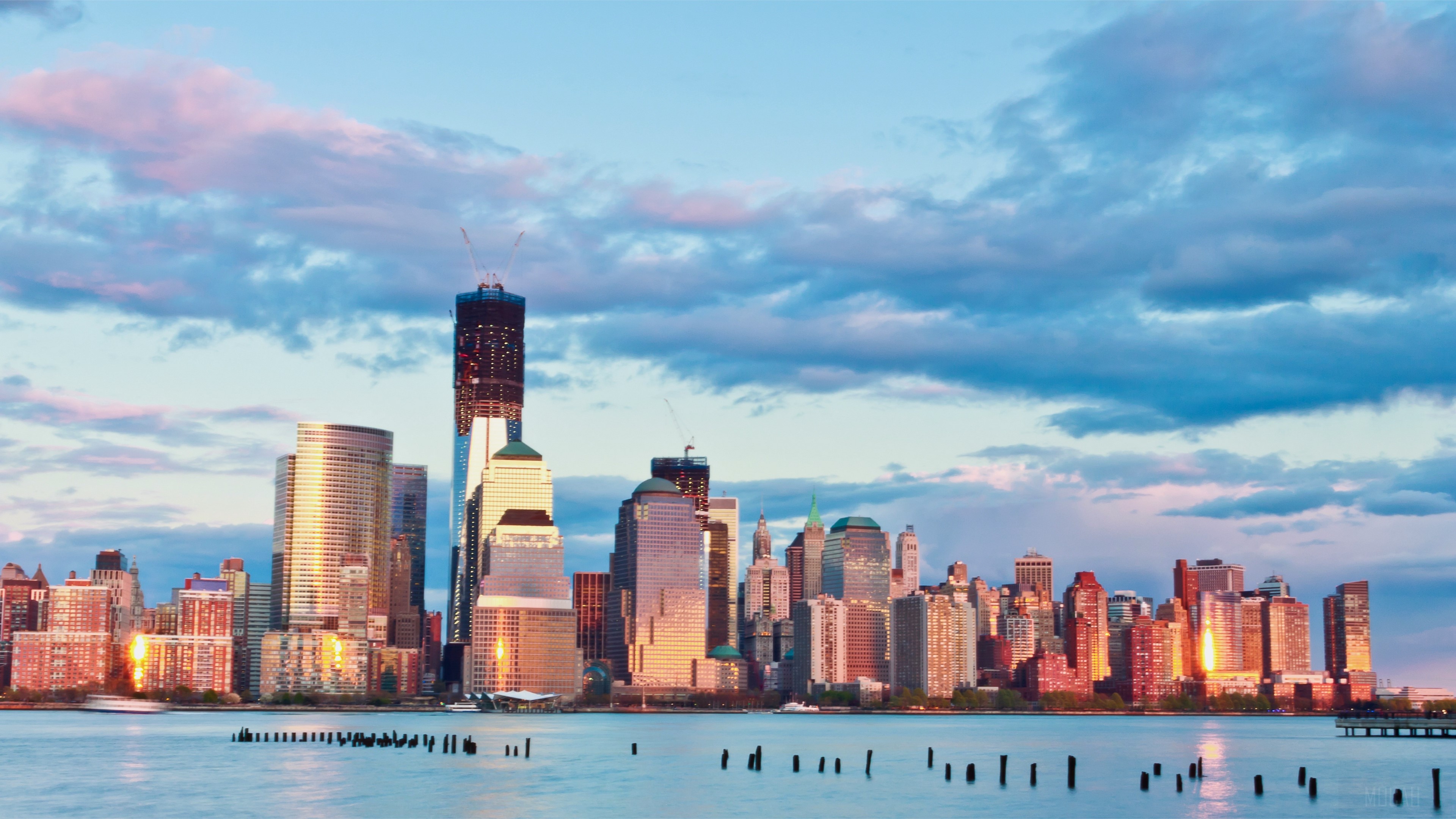 New York City skyline at sunset with clouds HD Wallpaper