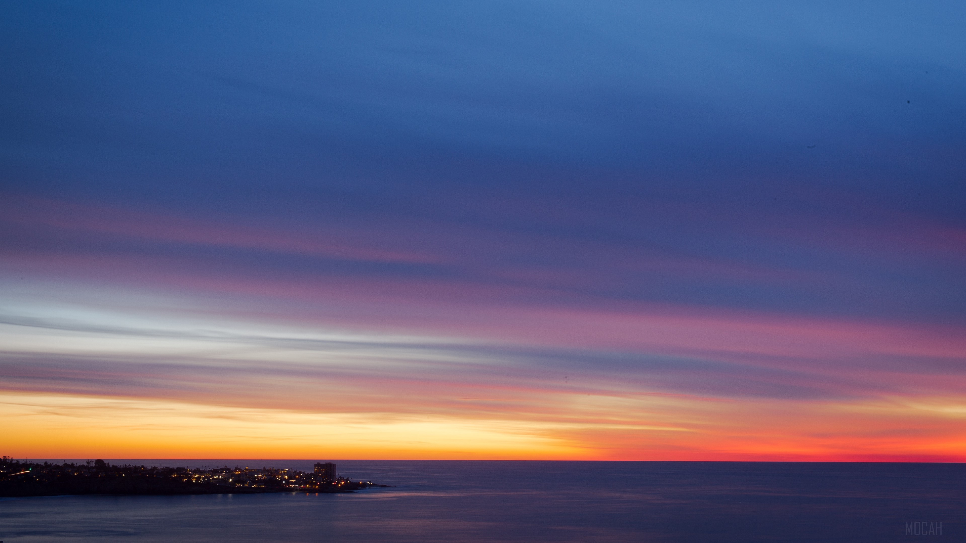 Sunset over a coastal city 4K HD Wallpaper