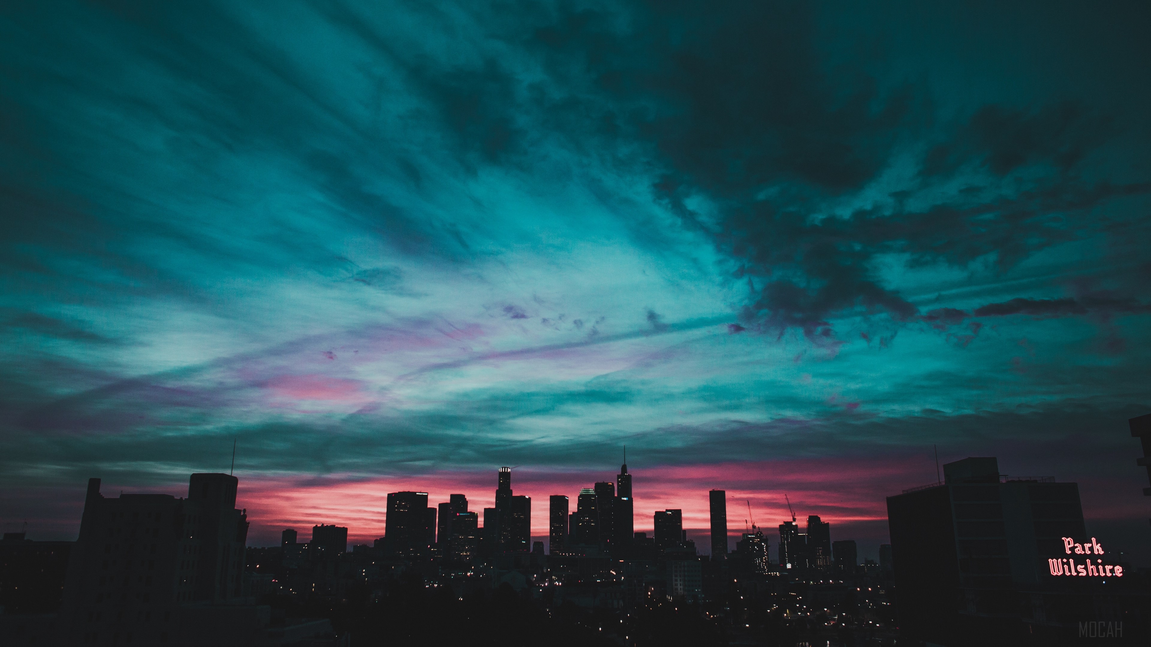 City skyline at sunset with colorful clouds HD Wallpaper