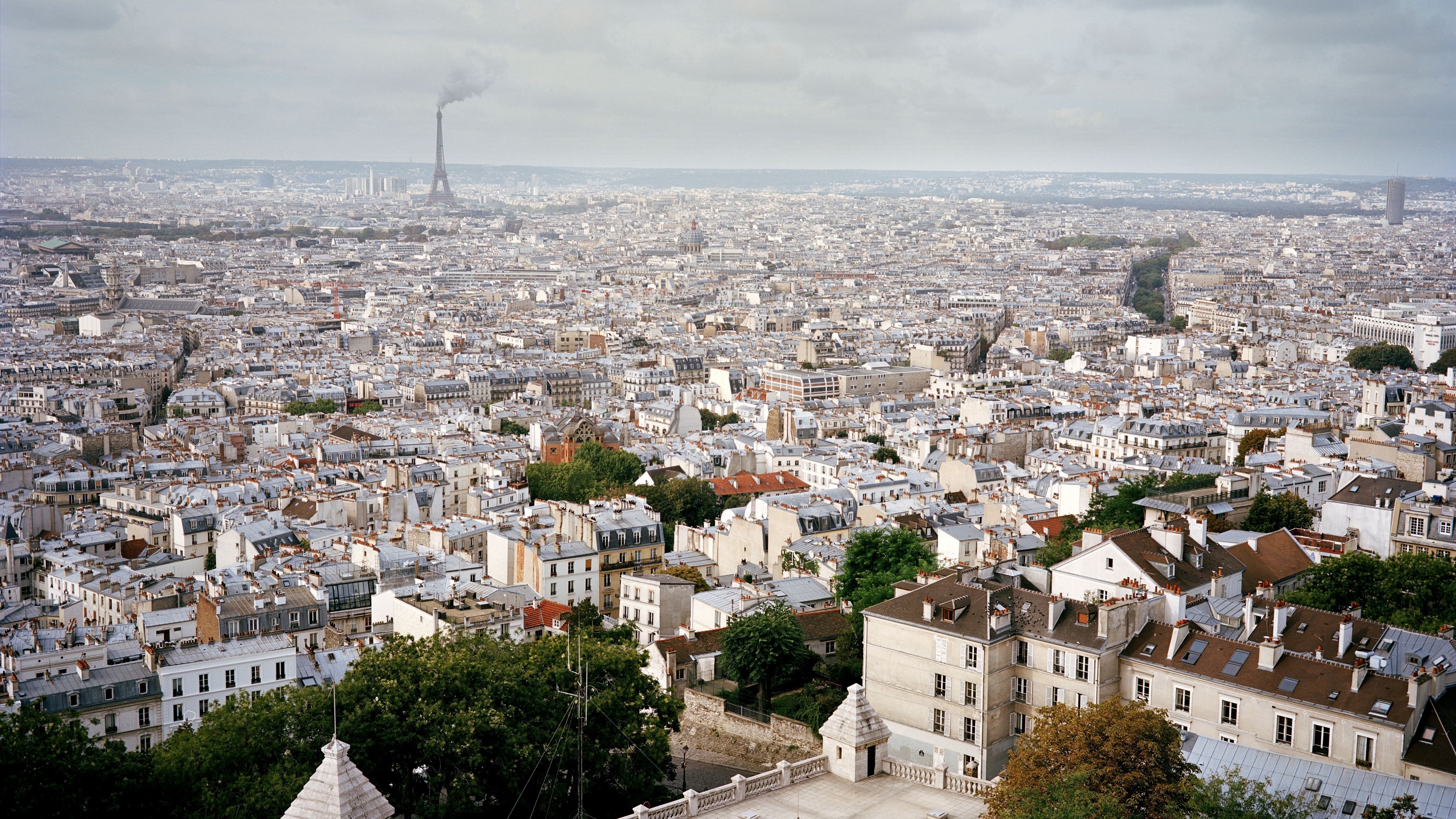 Paris skyline with Eiffel Tower and rooftops 4K HD Wallpaper