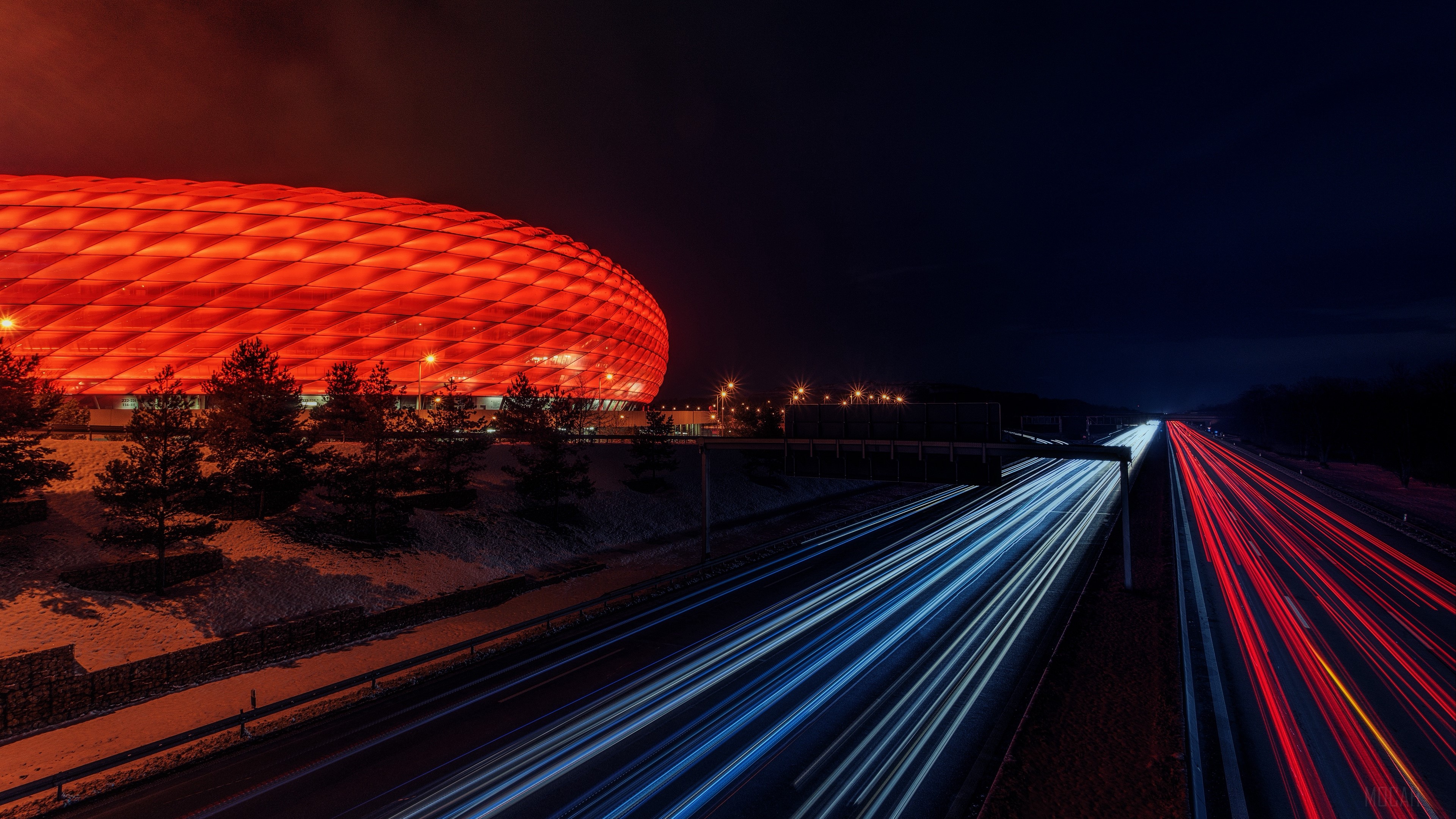 Allianz Arena stadium at night with light trails on highway HD Wallpaper