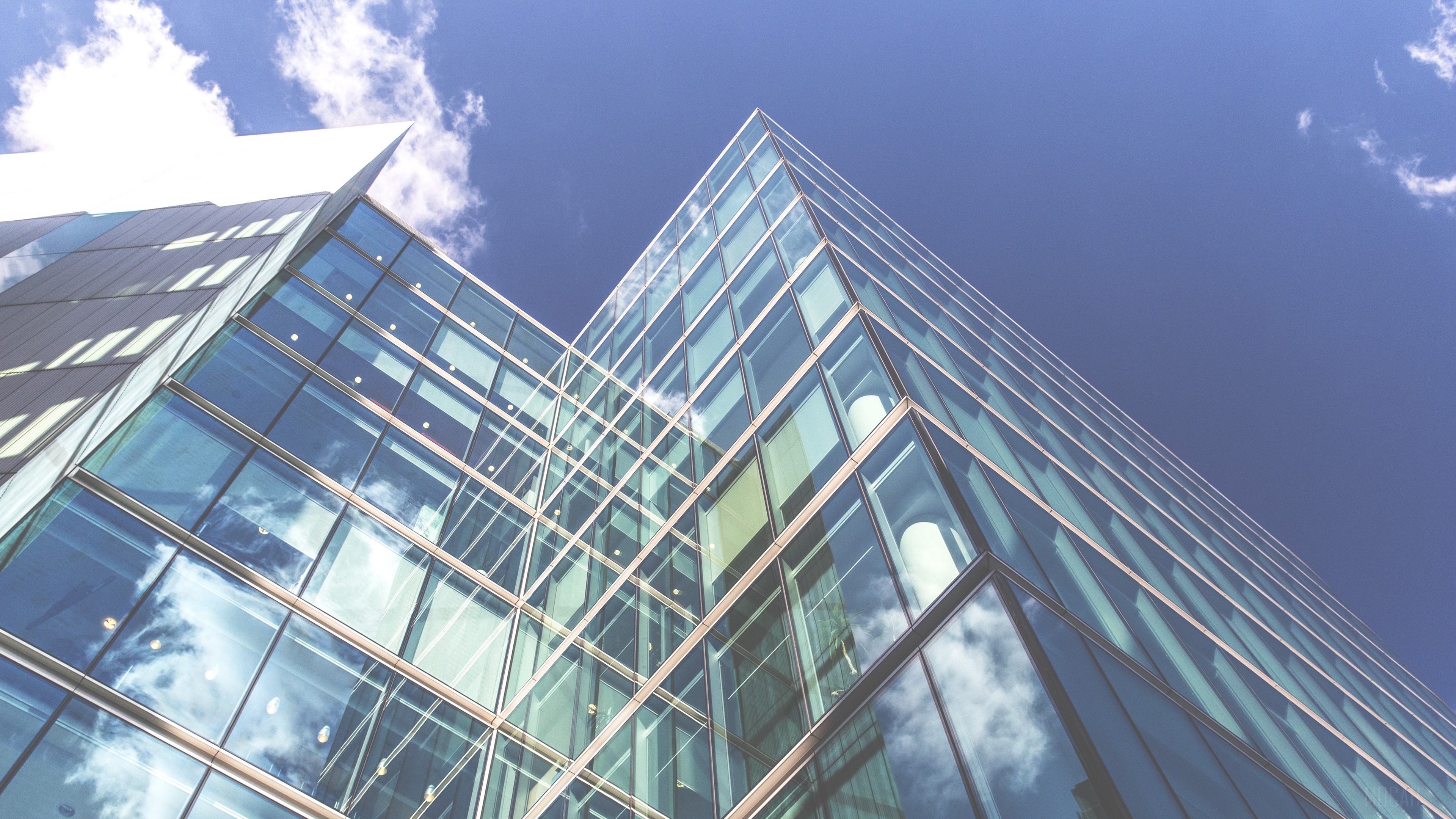 Modern glass building against blue sky with clouds HD Wallpaper