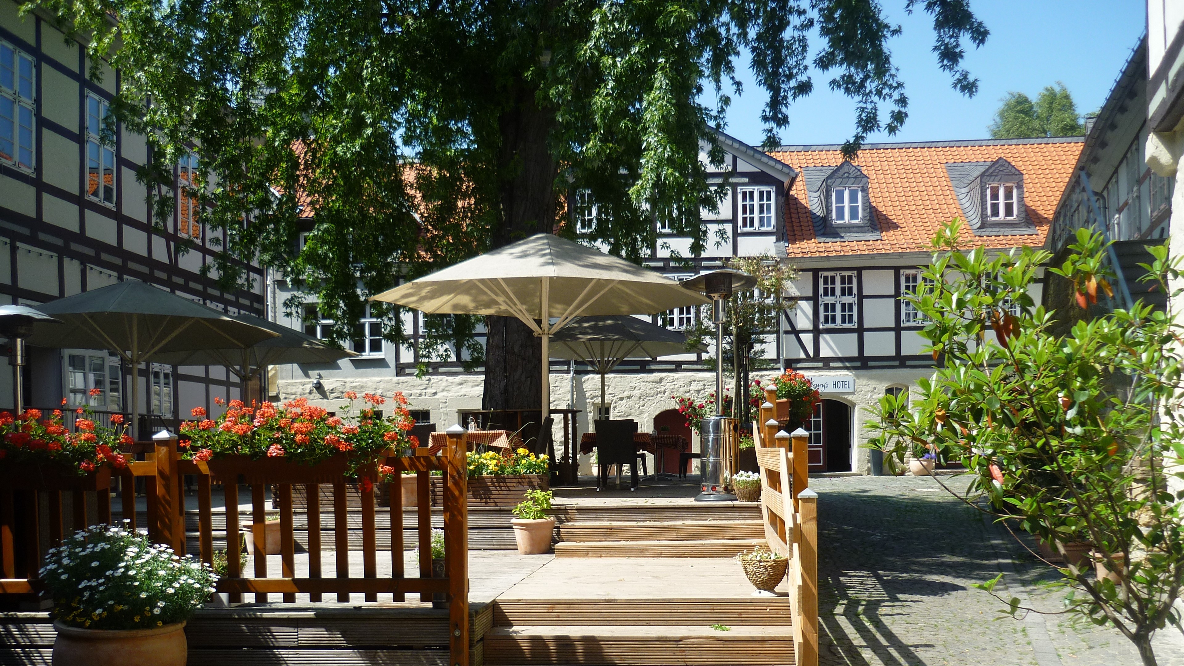 Courtyard with half-timbered buildings and flowers HD Wallpaper