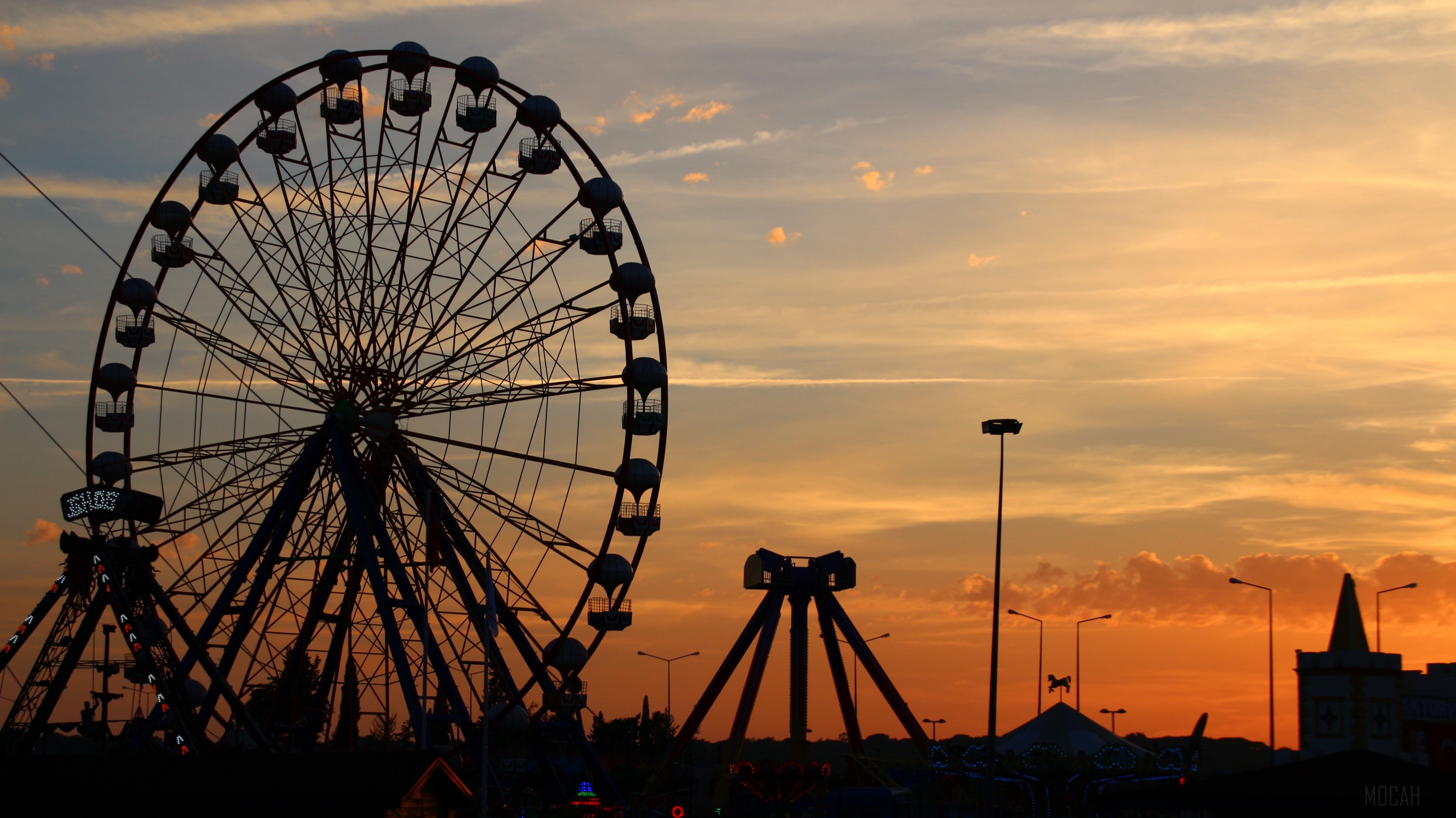 Ferris wheel and amusement park rides at sunset HD Wallpaper
