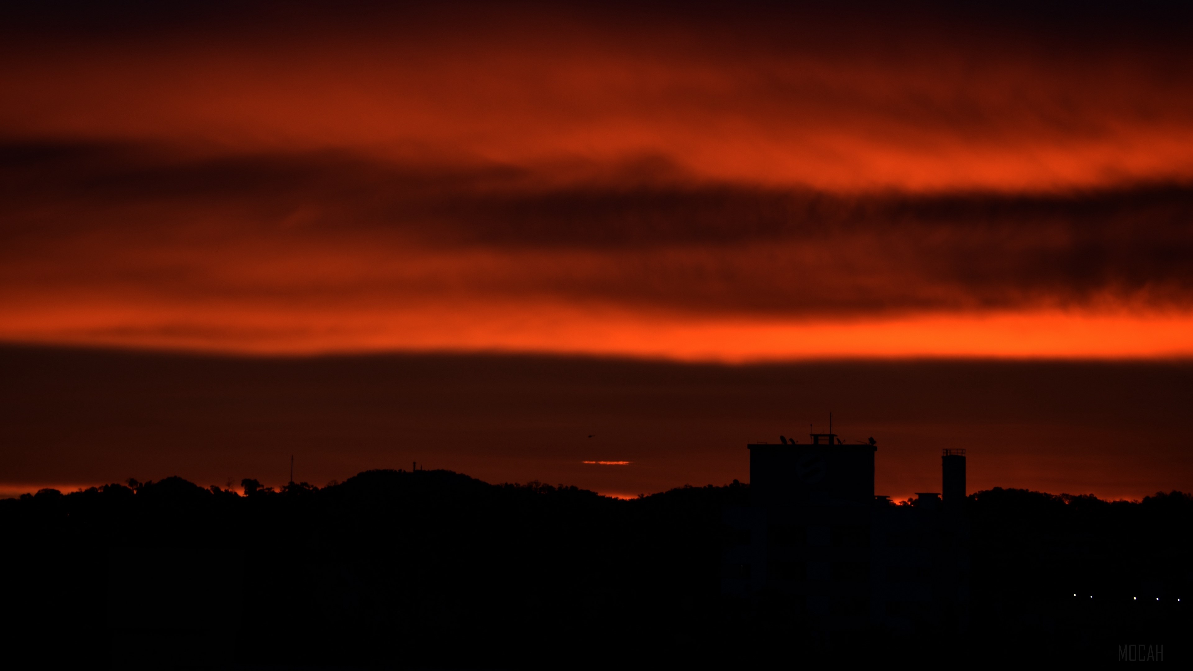City skyline at sunset with dramatic orange clouds 4K HD Wallpaper