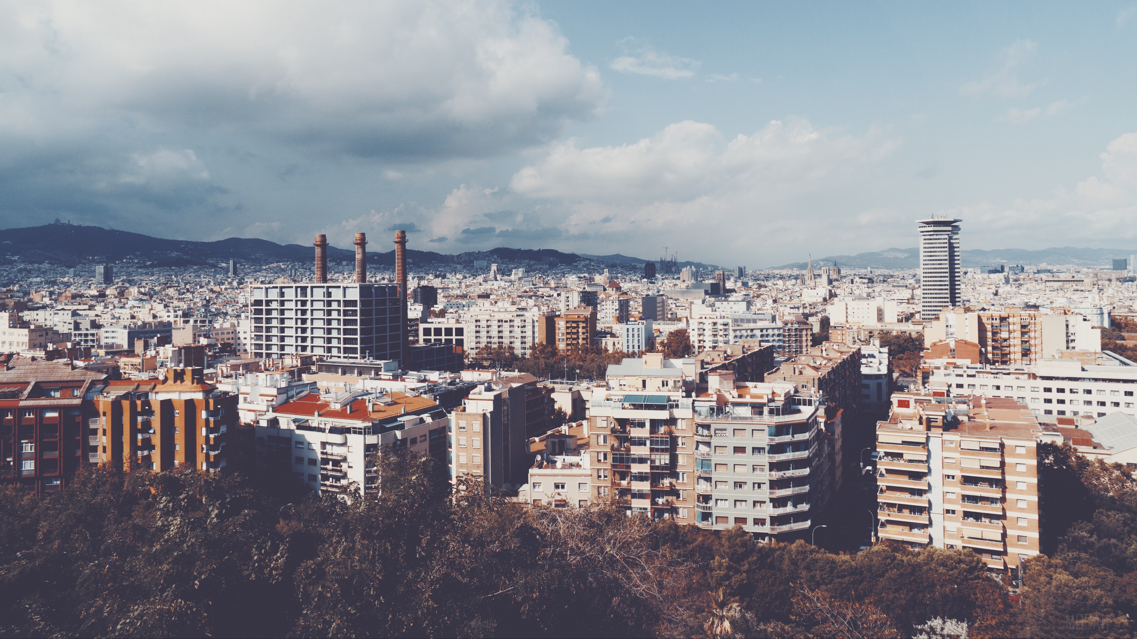 Panorama of Barcelona city with buildings and mountains HD Wallpaper