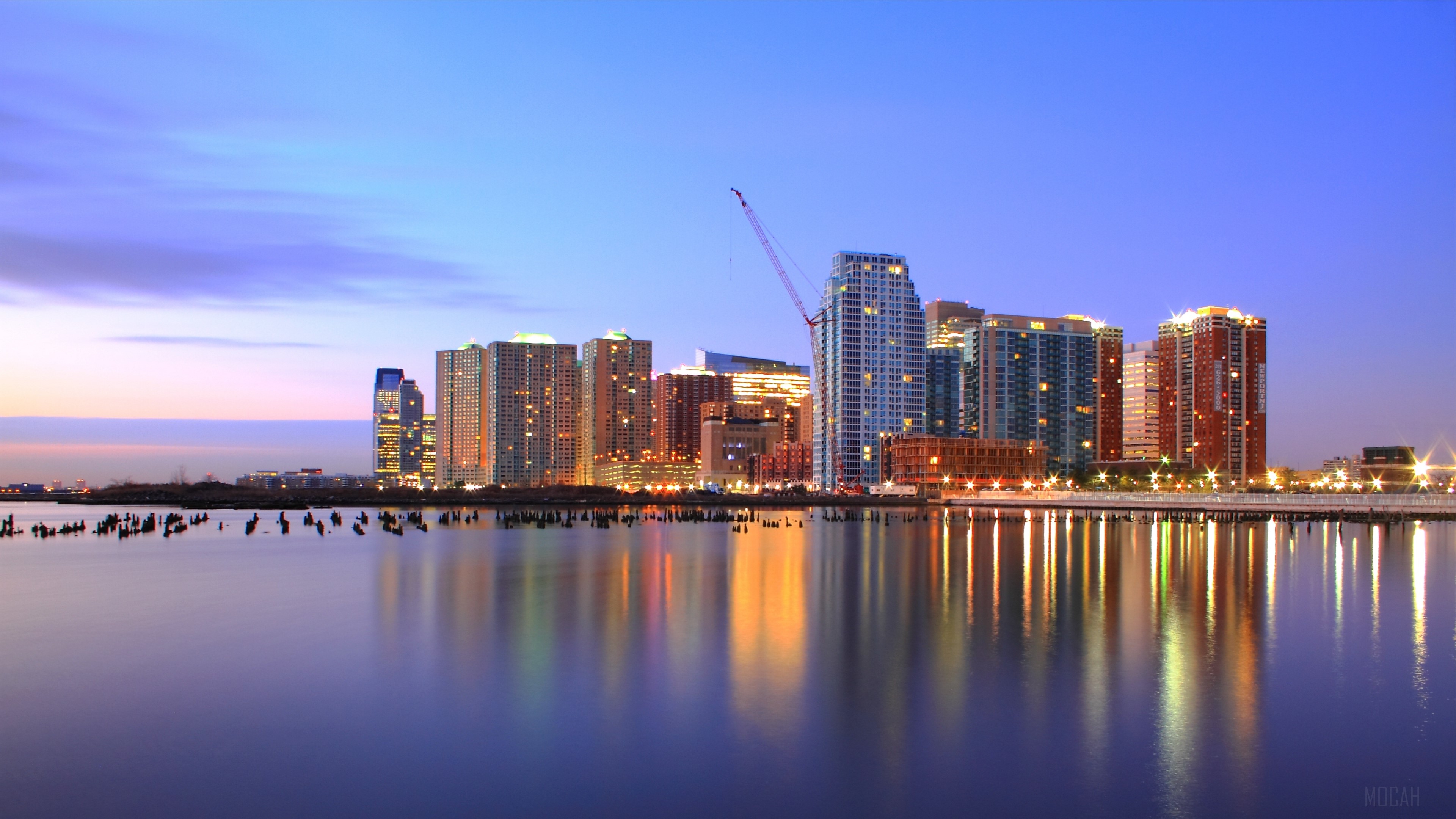 Jersey City skyscrapers at sunset with river reflection HD Wallpaper