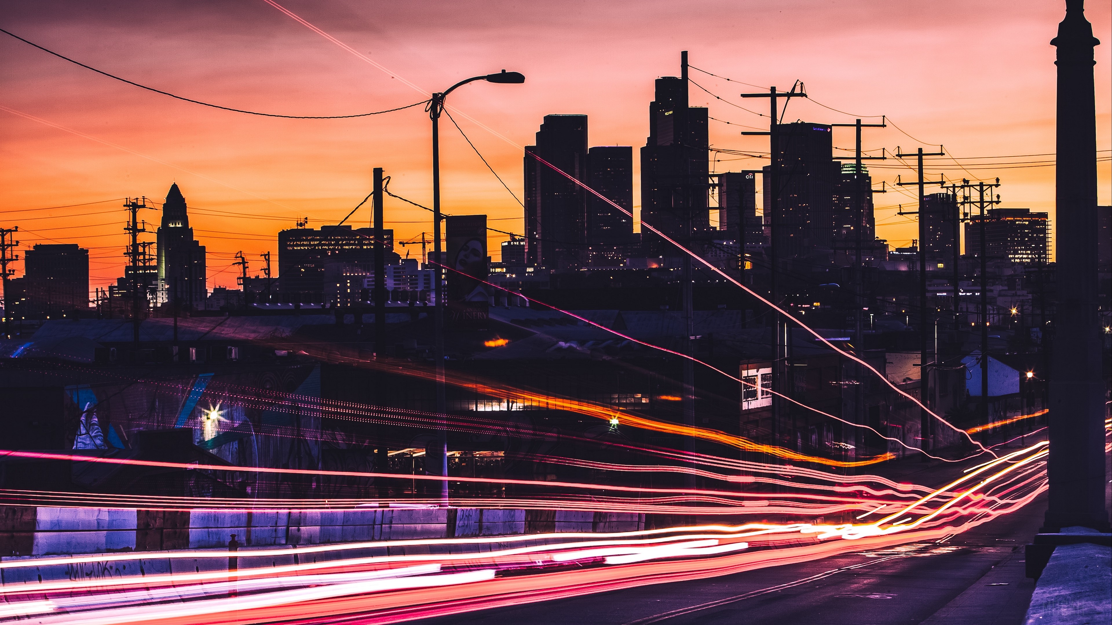 City skyline at sunset with light trails HD Wallpaper