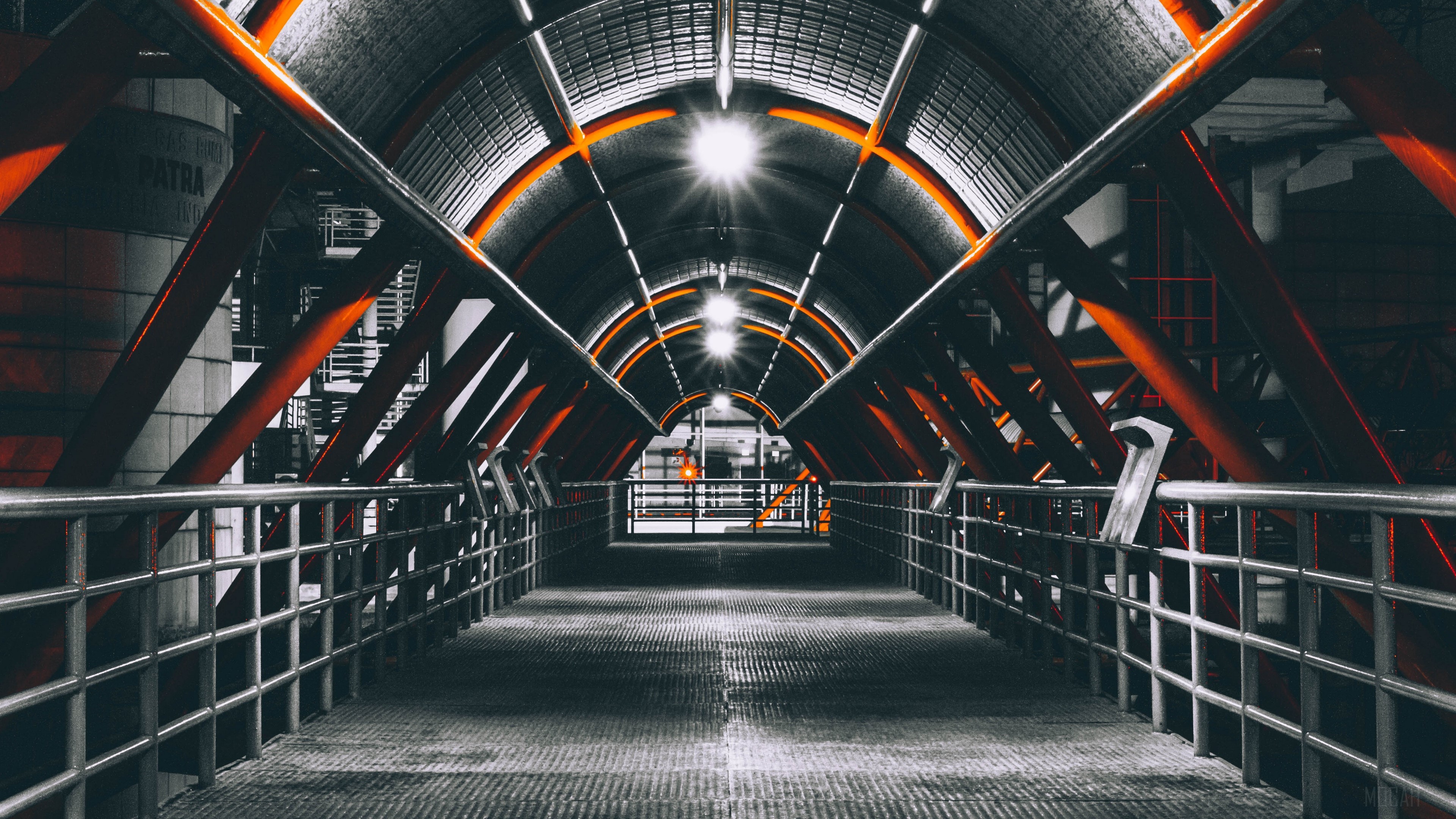 Industrial walkway with orange beams and lights HD Wallpaper