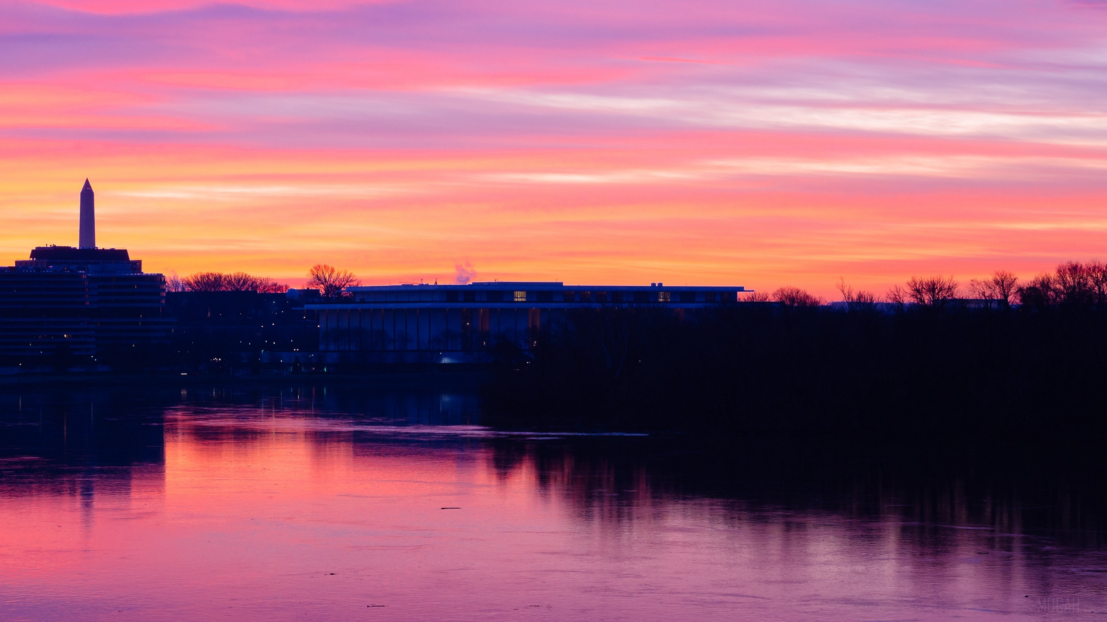 Washington Monument and buildings at sunset over river HD Wallpaper
