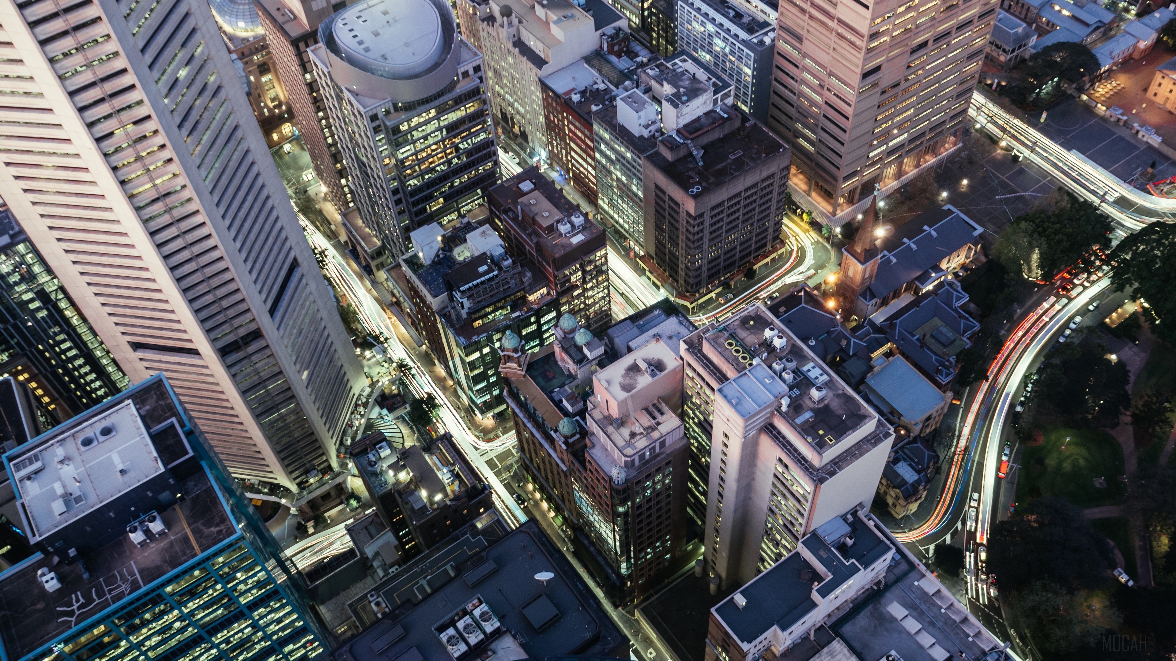 Aerial view of a city at night with light trails HD Wallpaper