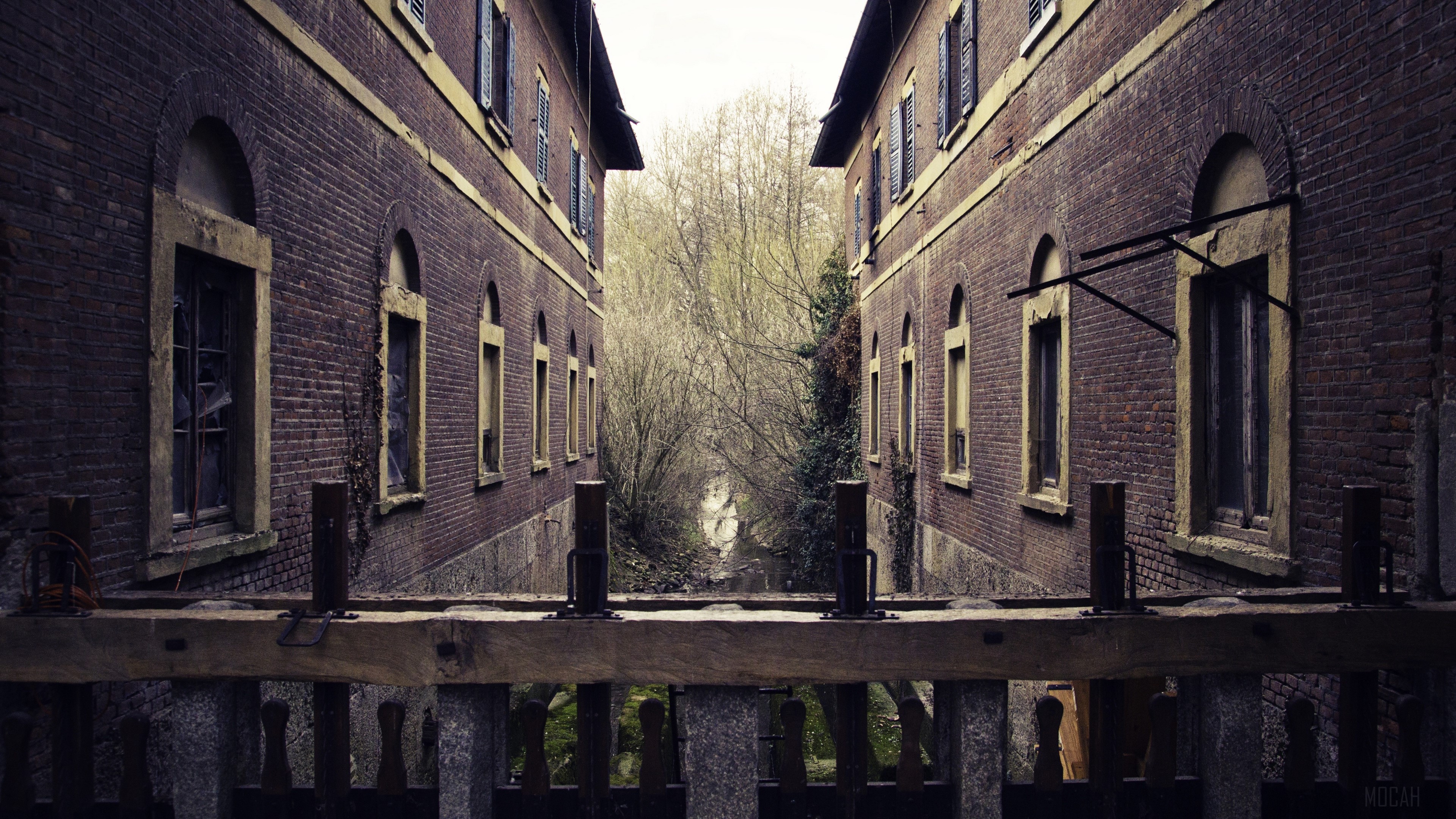 Two brick buildings with a canal in between HD Wallpaper