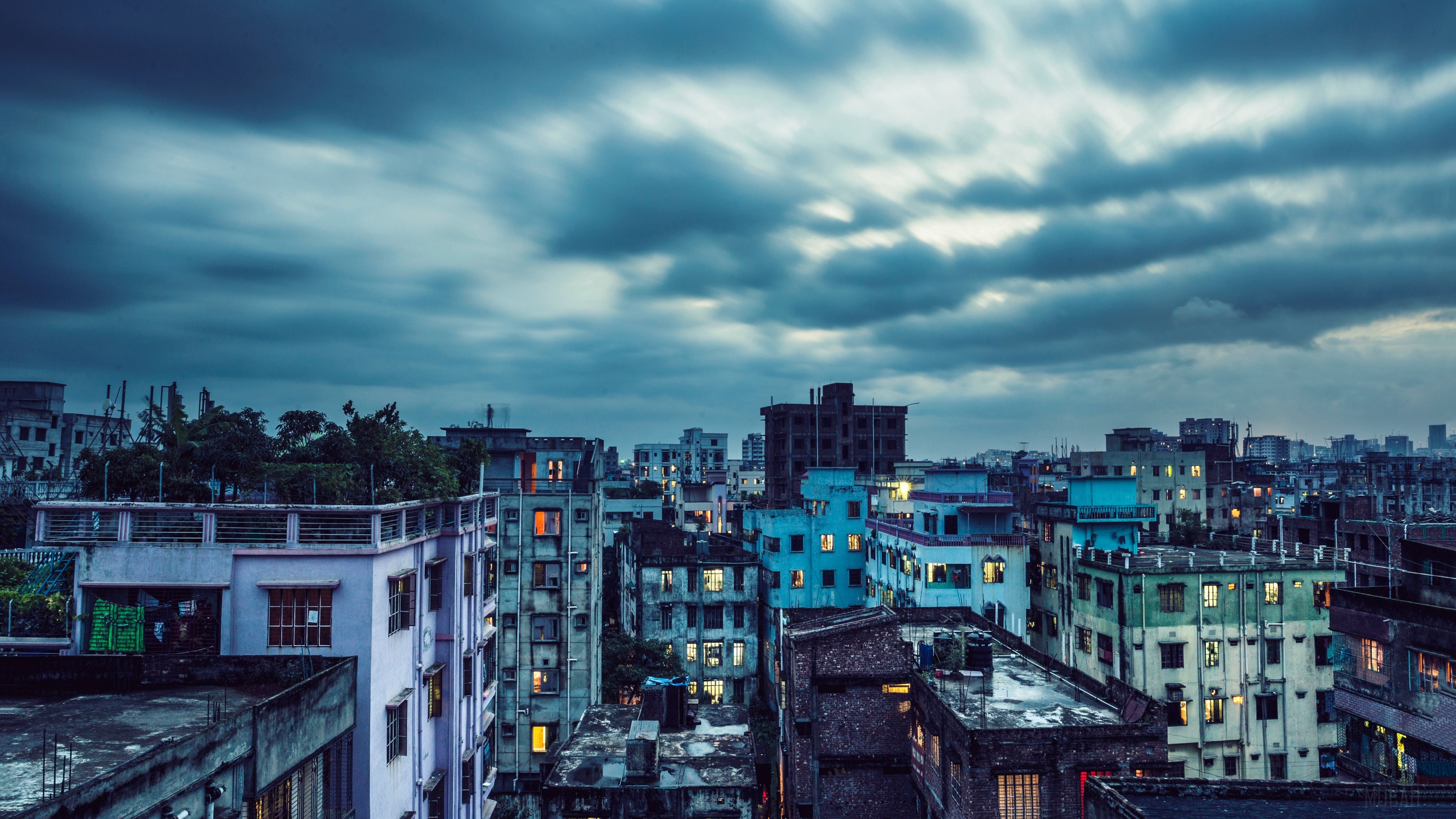 Cityscape with buildings under cloudy sky 4K HD Wallpaper