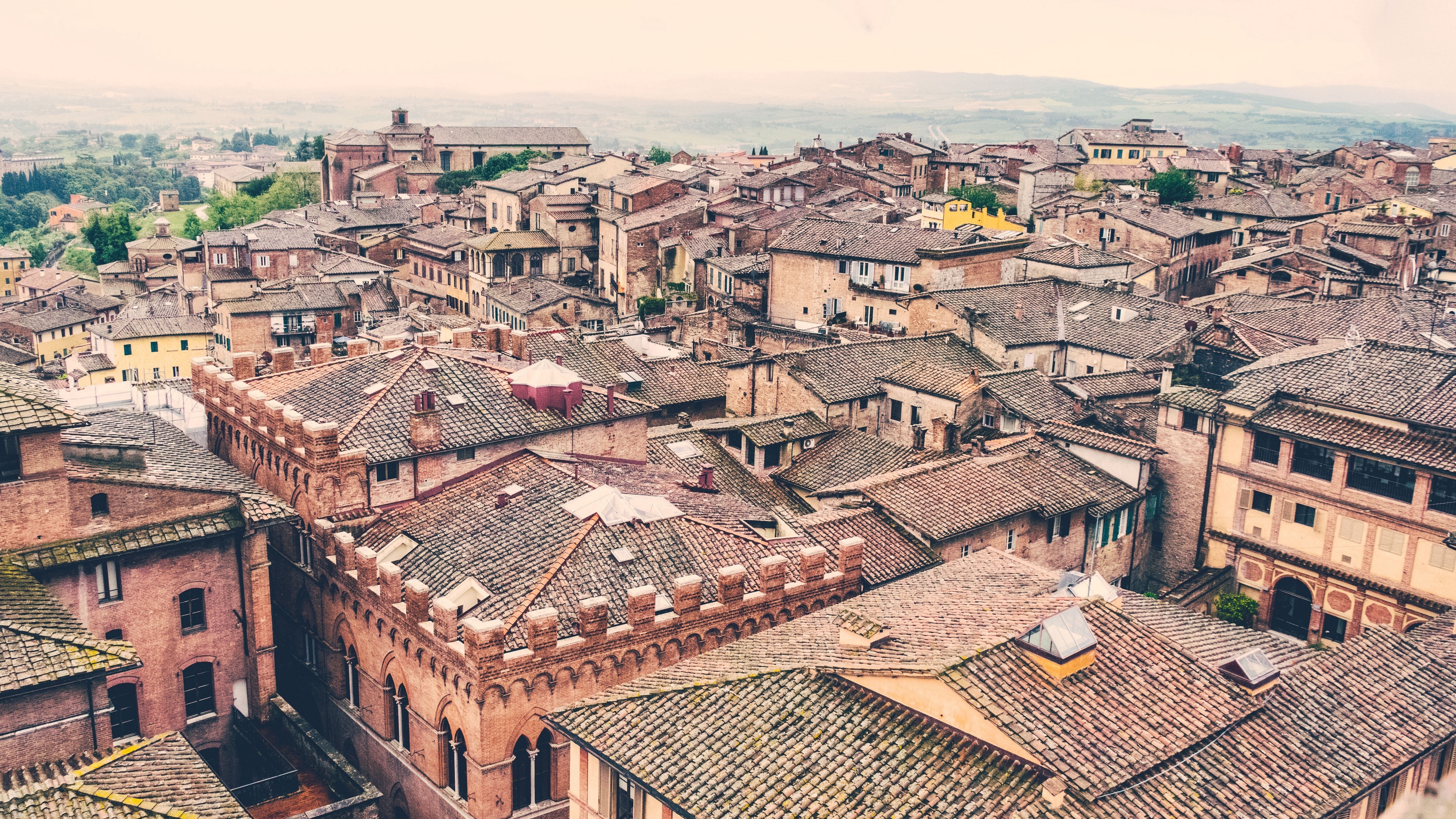 Cityscape with terracotta roofs and architecture HD Wallpaper